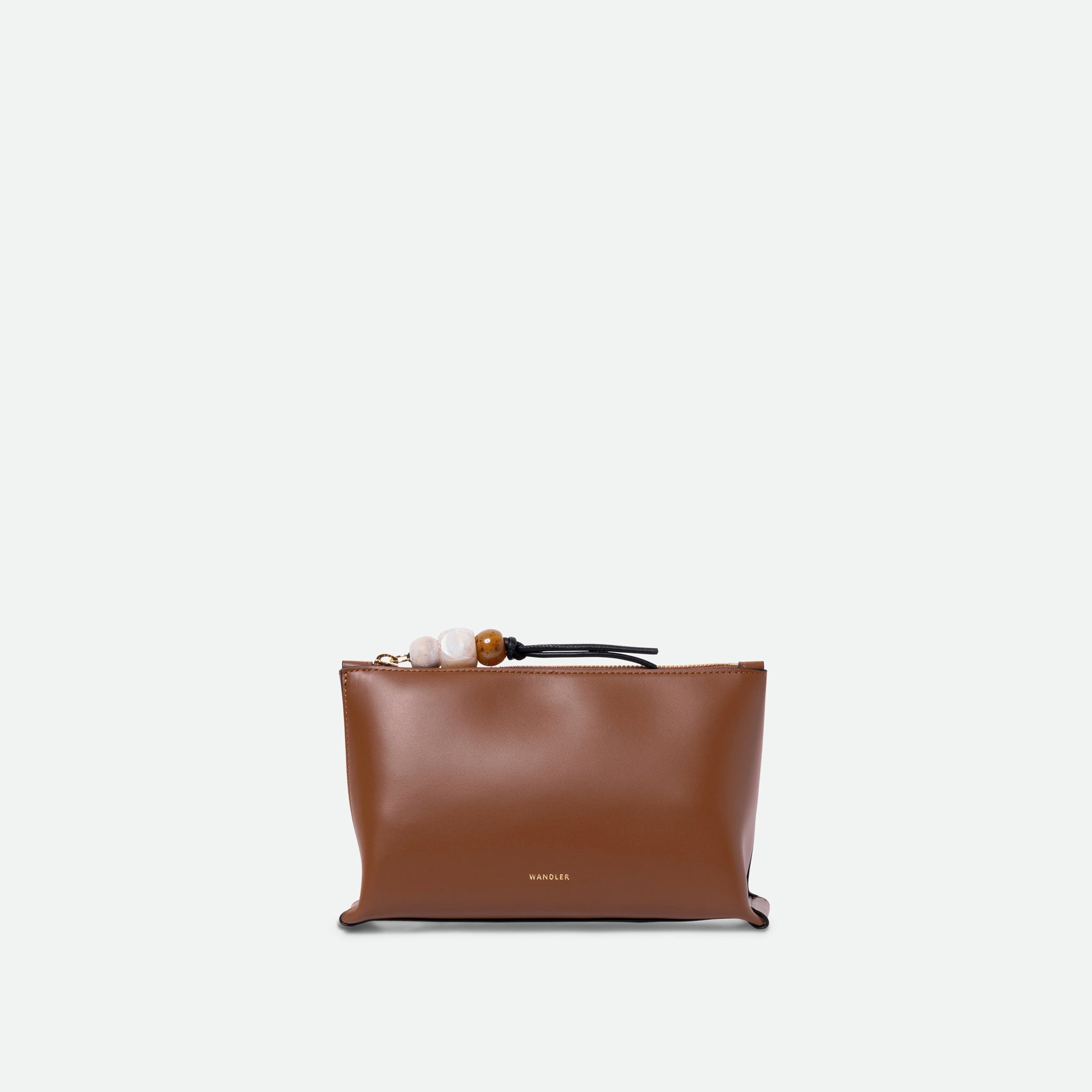 Wandler Ida Case in Saddle, made from calf leather with golden zipper hardware and charm, front view.