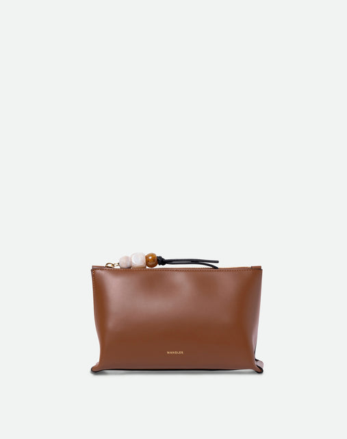 Wandler Ida Case in Saddle, made from calf leather with golden zipper hardware and charm, front view.