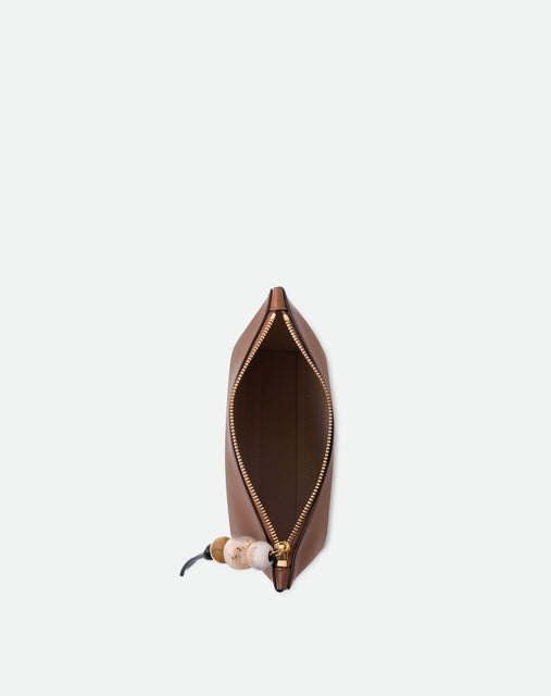 Wandler Ida Case in Saddle, made from calf leather with golden zipper hardware and charm, topside view with open zipper, inside of the bag is visible.