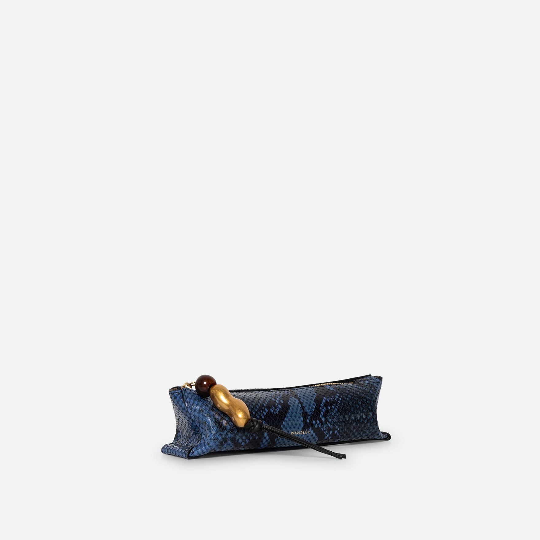 Wandler Ida Case Small in Orion Python calf leather with golden zipper hardware and charm, three quarters view.