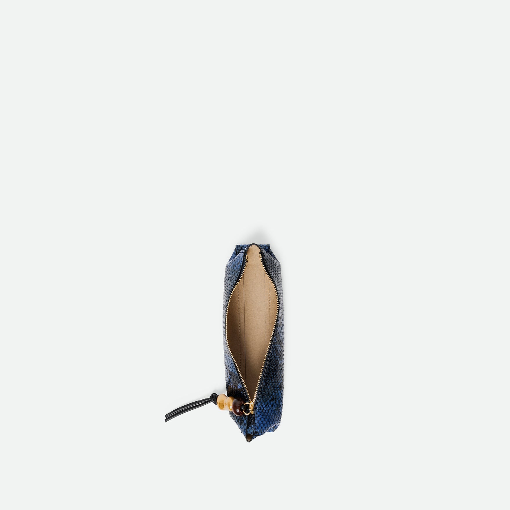Wandler Ida Case Small in Orion Python calf leather with golden zipper hardware and charm, pictured from above with the zipper open, giving a view into the inside. 