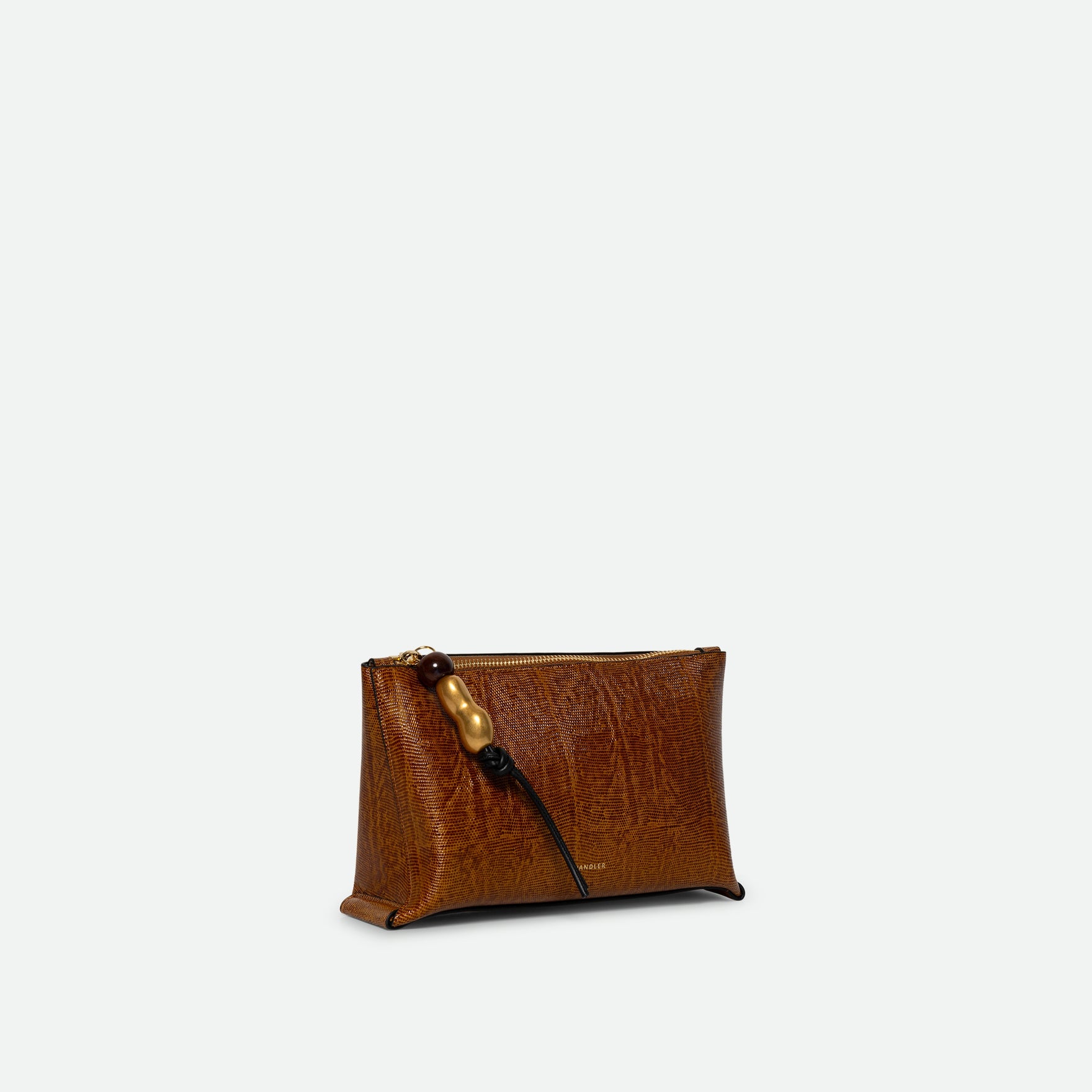 Wandler Ida Case in Tabacco Lizzard, soft calf leather with golden zipper hardware and charm, three quarters view. 