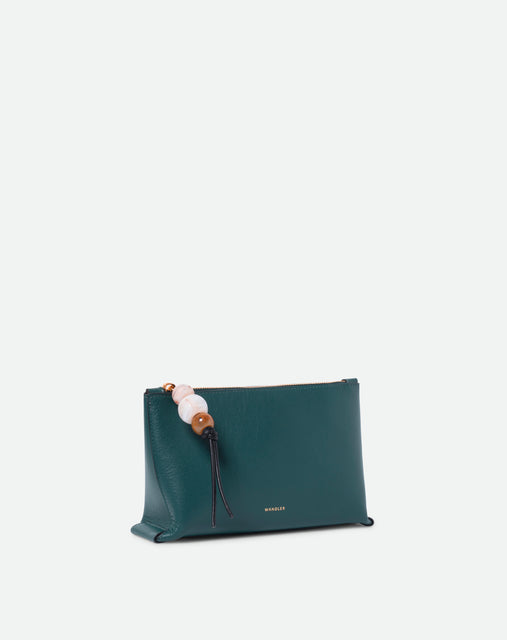 Wandler Ida Case in Teal made from calf leather with golden zipper hardware and charm, three quarters view.