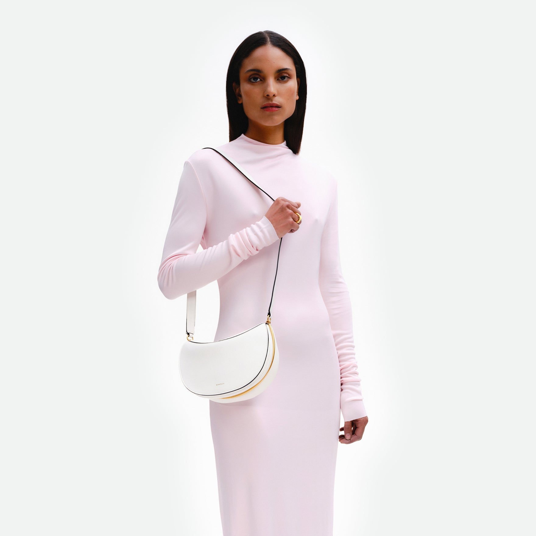 Wandler Kate Bag in the color Luck, white, Italian calf leather with golden hardware and adjustable shoulder strap, pictured on model, worn on the shoulder. 