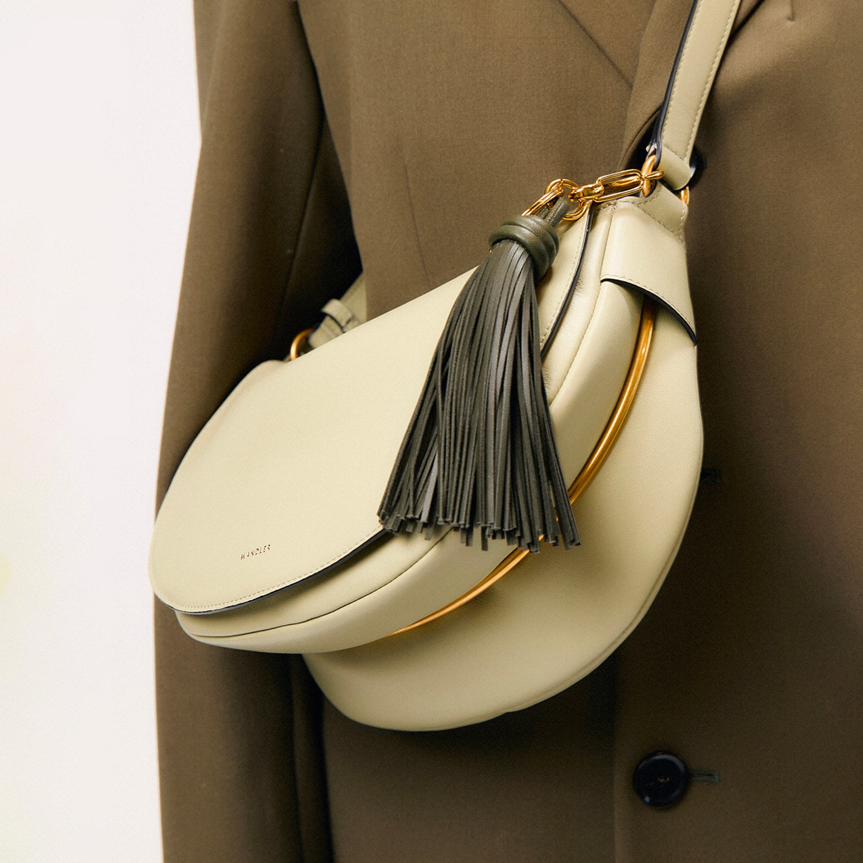Wandler Bag Charm Olive Tassel, pictured on a Kate bag, being used as a bag charm.