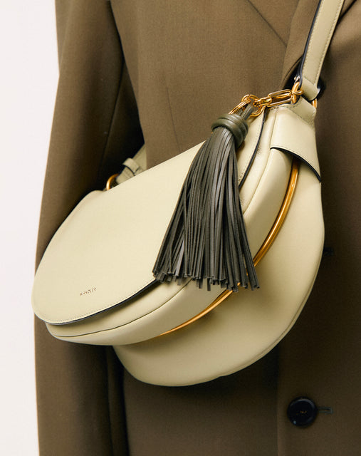 Wandler Bag Charm Olive Tassel, pictured on a Kate bag, being used as a bag charm.