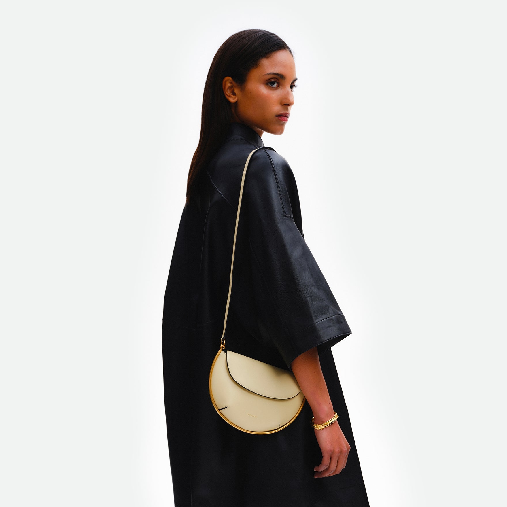 Wandler Kate Mini Crossbody in Helio Italian calf leather with golden hardware and adjustable strap, bag pictured being worn on the shoulder by model.