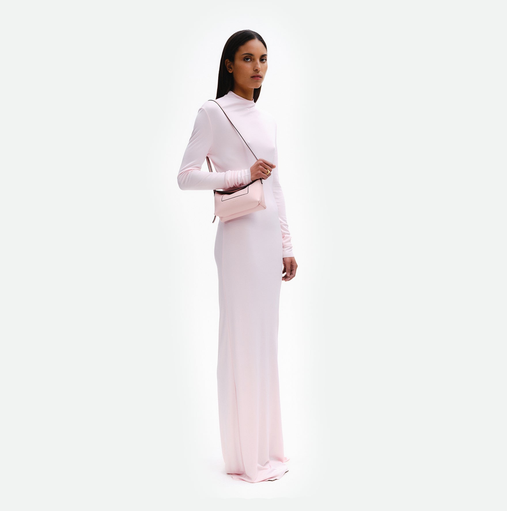 Wandler Penelope Slouch Mini in Rose Crust, pink, Italian calf leather with golden hardware and slim adjustable strap, pictured on model worn on the shoulder, full body picture. 