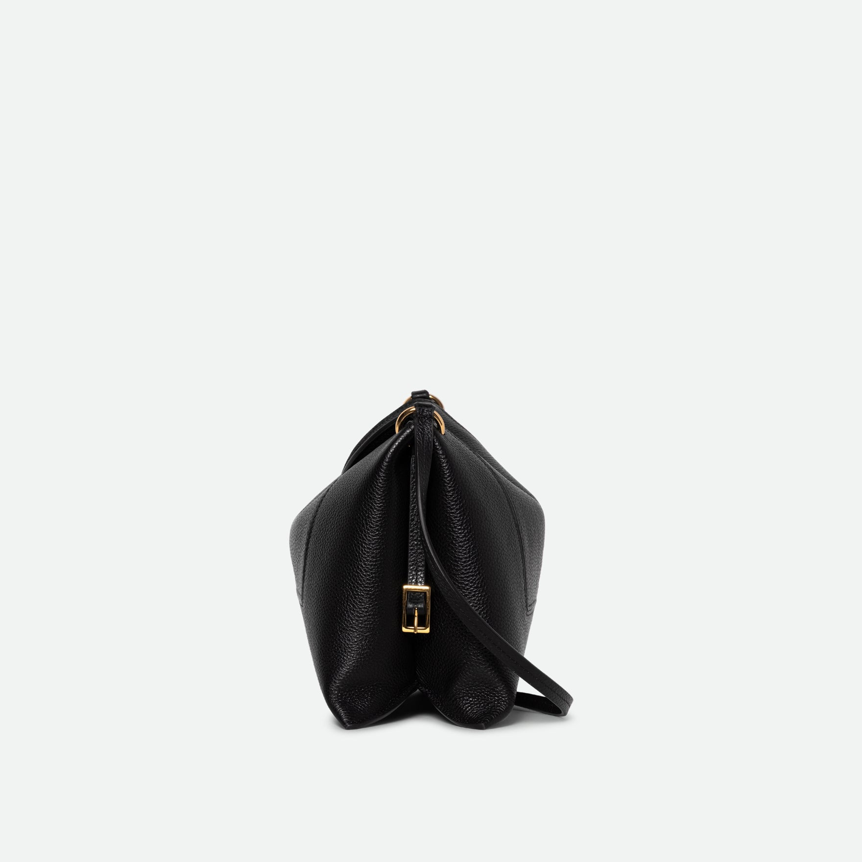 Wandler Penelope Slouch Bag in the color Black Crust, made from smooth calf leather with golden hardware and adjustable slim strap, side view. 