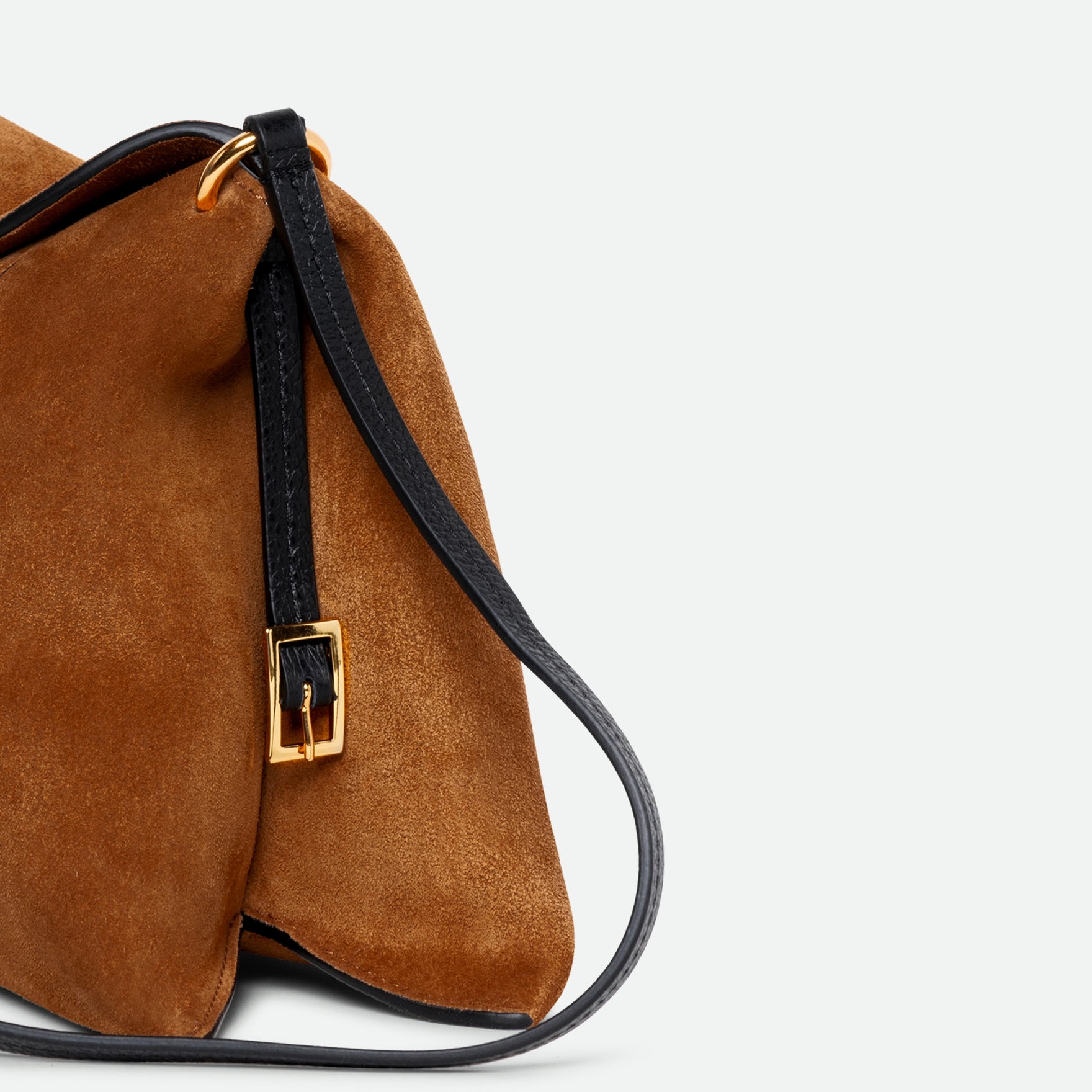 Wandler Penelope Slouch Bag in the color Cognac Suede, made from calf leather with golden hardware and adjustable slim strap, close up detailing the side of the bag.