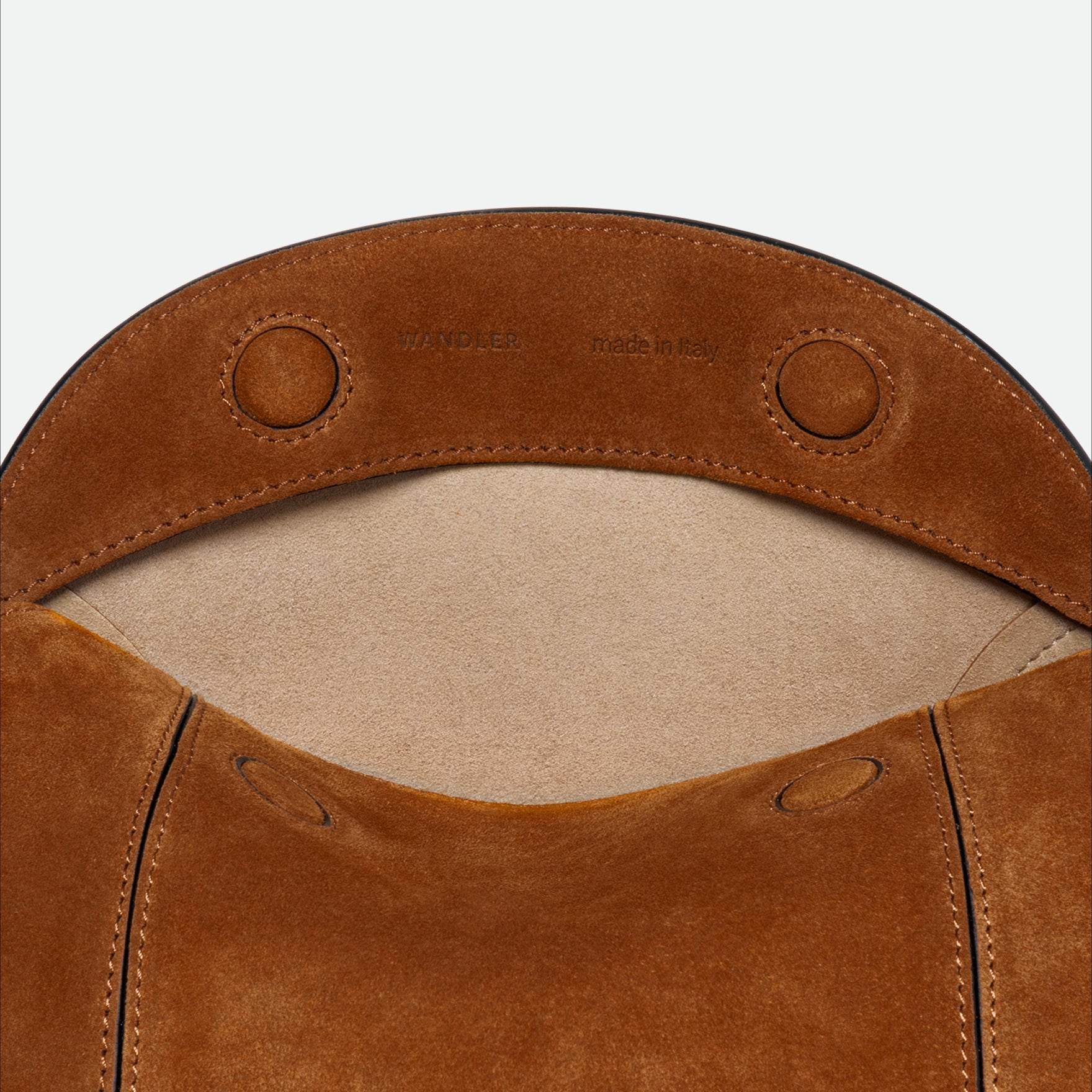 Wandler Penelope Slouch Bag in the color Cognac Suede, made from calf leather with golden hardware and adjustable slim strap, close up detailing the leather.