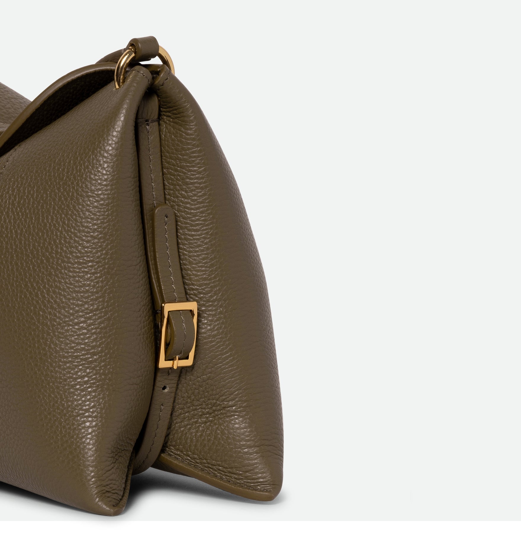 Wandler Penelope Slouch Bag in the color Olive Crust, green, made from smooth calf leather with golden hardware and adjustable slim strap, close up detailing the buckle and leather. 