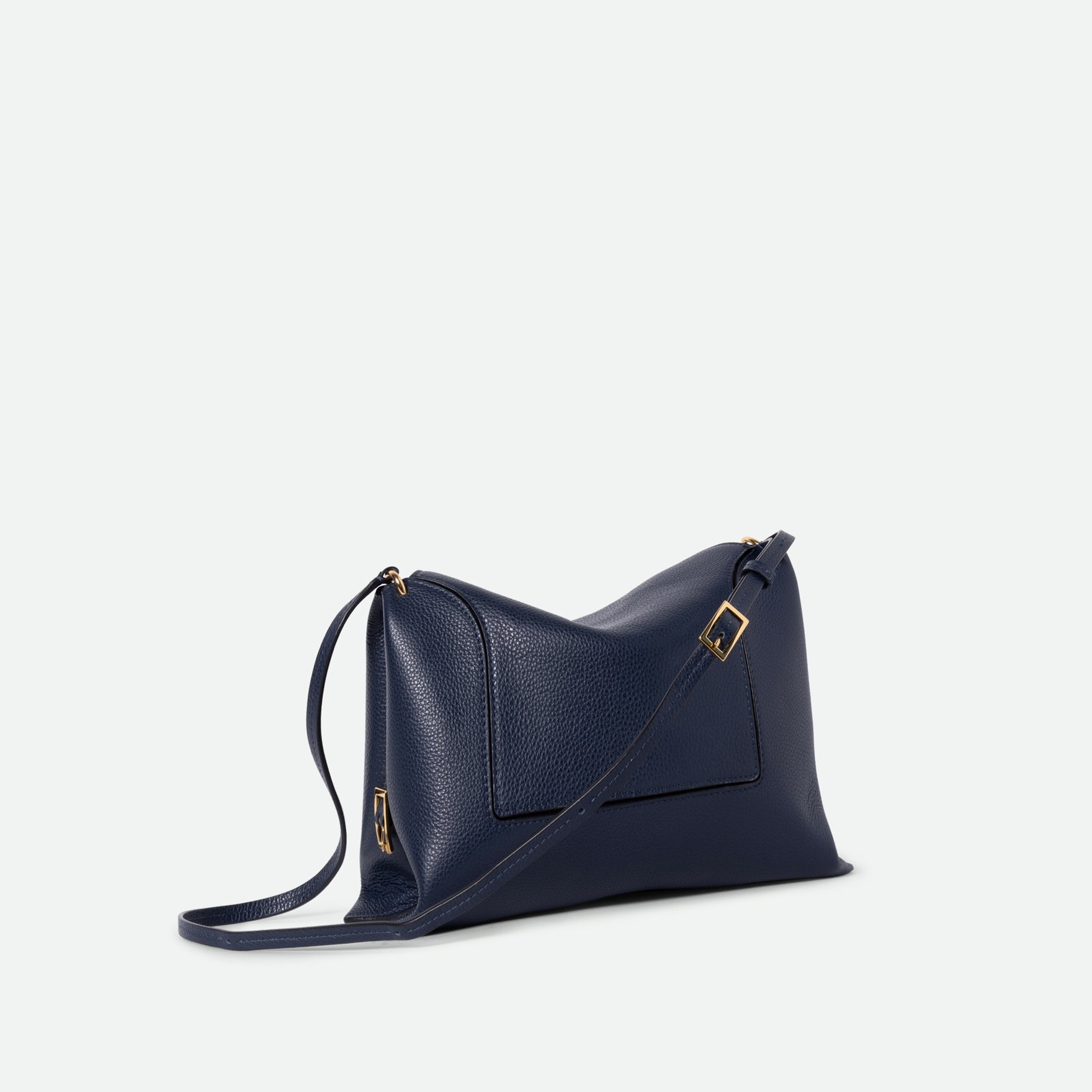 Wandler Penelope Slouch Bag in the color Orion Crust deep dark blue, made from calf leather with golden hardware and adjustable slim strap, three quarters view. 