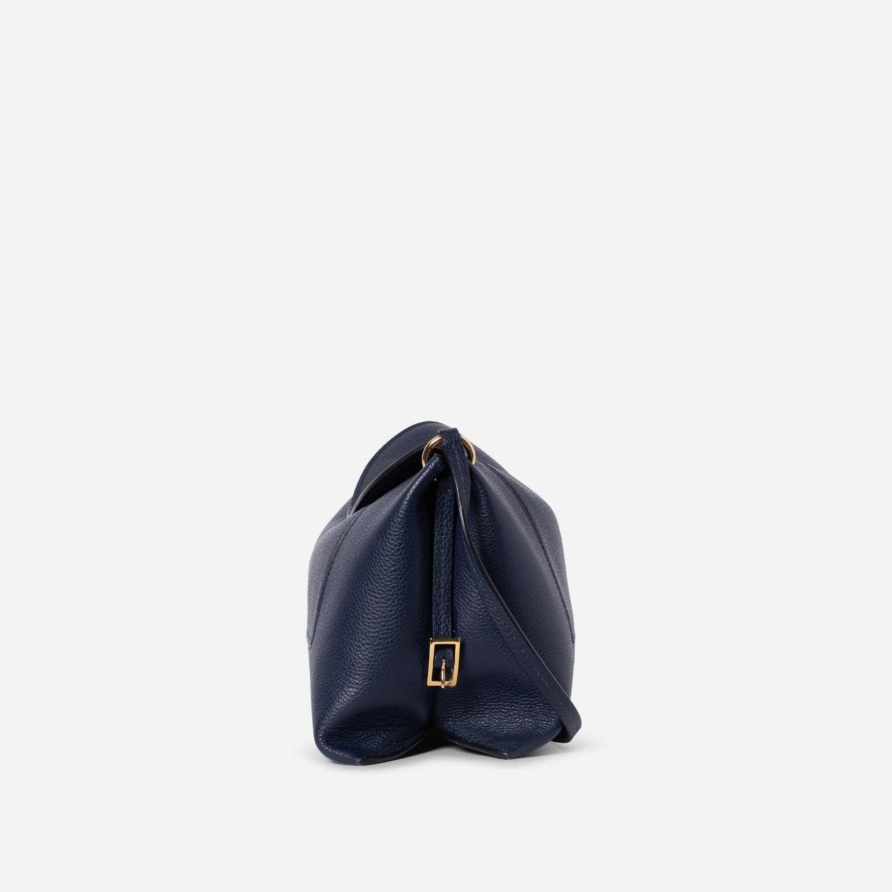 Wandler Penelope Slouch Bag in the color Orion Crust deep dark blue, made from calf leather with golden hardware and adjustable slim strap, side view.