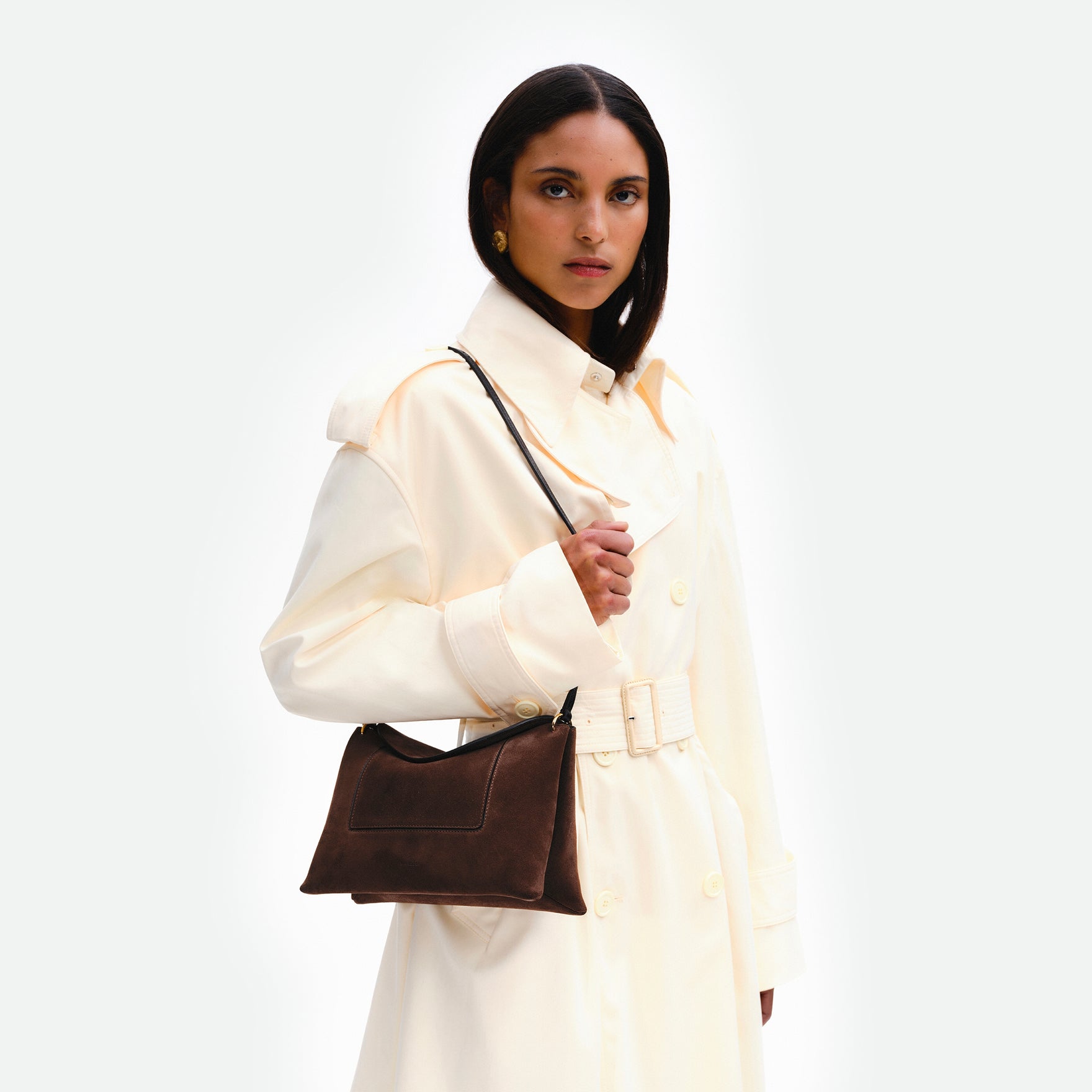 Wandler Penelope Slouch Bag in the color Palissander Suede, made from calf leather with golden hardware and adjustable slim strap, pictured being worn on the shoulder by model.
