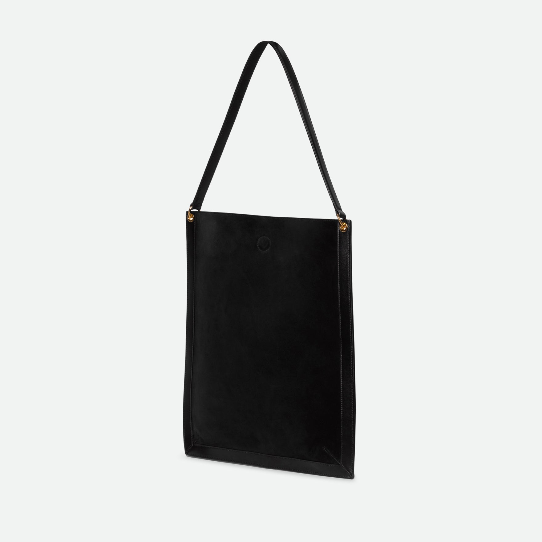 Wandler Penny Tote in the color Black Suede, made from Italian calf leather with hand-painted black edges and golden hardware, three quarters backside view.