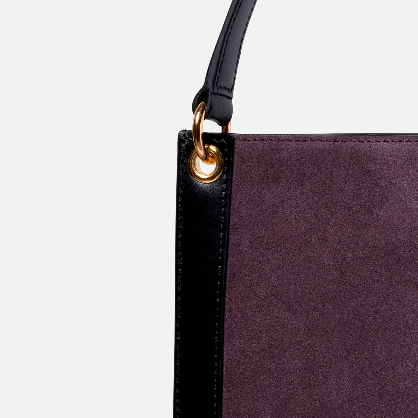 Wandler Penny Tote in the color Grape, made from Italian calf leather with hand-painted black edges and golden hardware, close up detailing leather and side.