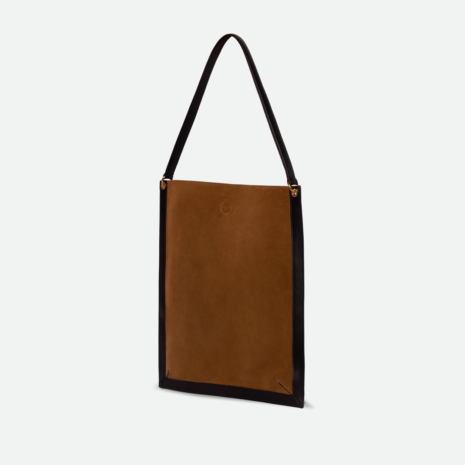 Wandler Penny Tote in the color Tabacco Suede, made from Italian calf leather with hand-painted black edges and golden hardware, three quarters backside view.