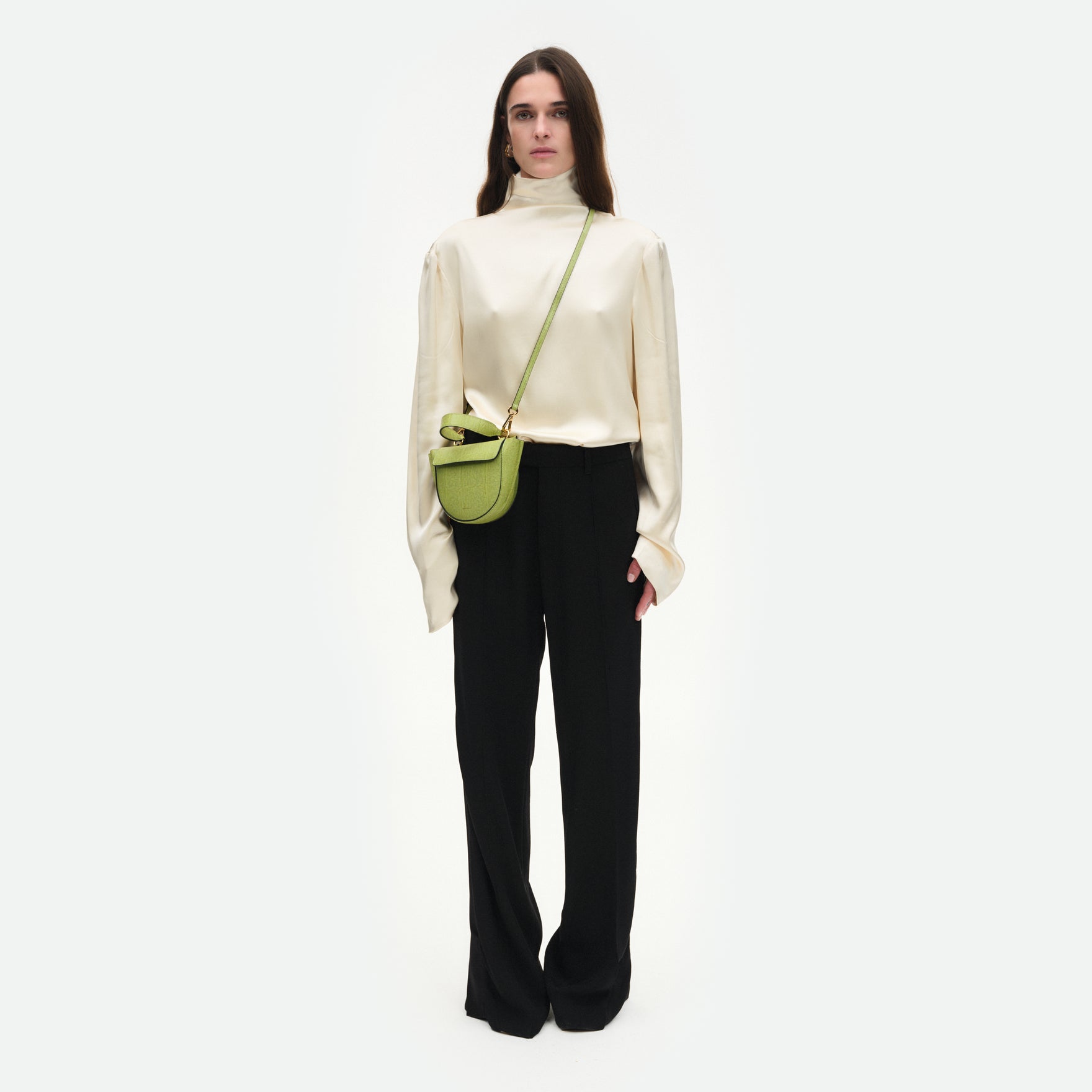 Wandler Hortensia Bag Piccola in the color Lime Lizzard, green, made from Italian calf leather with golden hardware and rounded silhouette, pictured on model, worn in a crossbody style, full body picture.