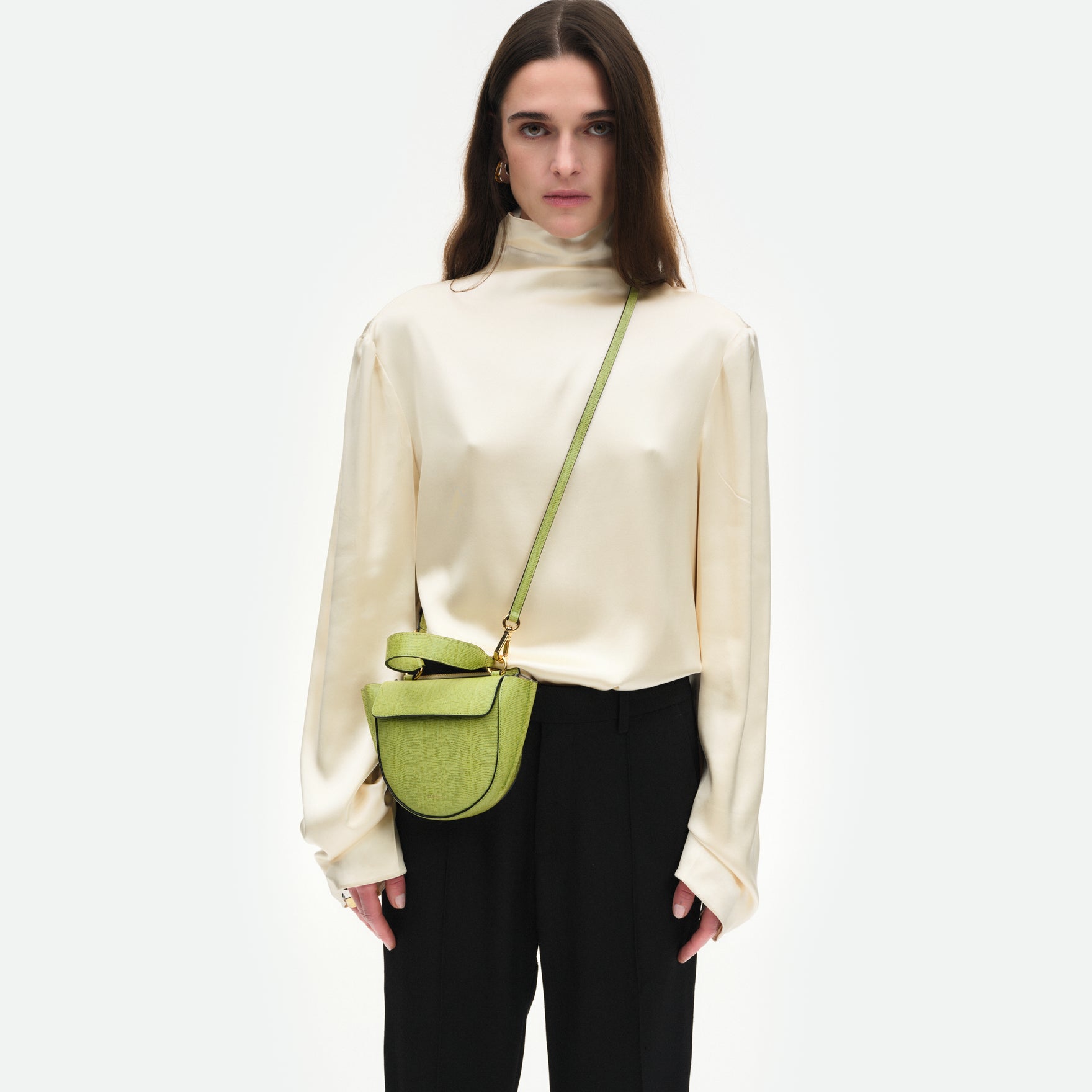 Wandler Hortensia Bag Piccola in the color Lime Lizzard, green, made from Italian calf leather with golden hardware and rounded silhouette, pictured on model, worn in a crossbody style.