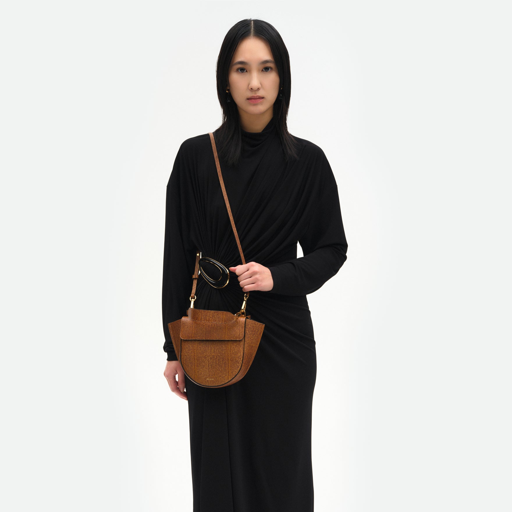 Wandler Hortensia Bag Mini in the color Tabacco Lizzard, warm brown with lizzard motive, made from Italian calf leather with golden hardware, rounded silhouette and top handle, pictured on model worn on the shoulder. 