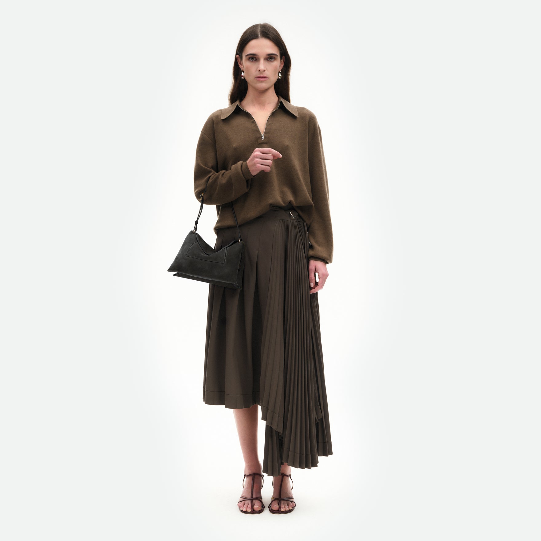 Wandler Penelope Slouch Bag in the colour Space Suede, grey, made from smooth calf leather with golden hardware and adjustable slim strap, pictured on model, worn on the forearm.