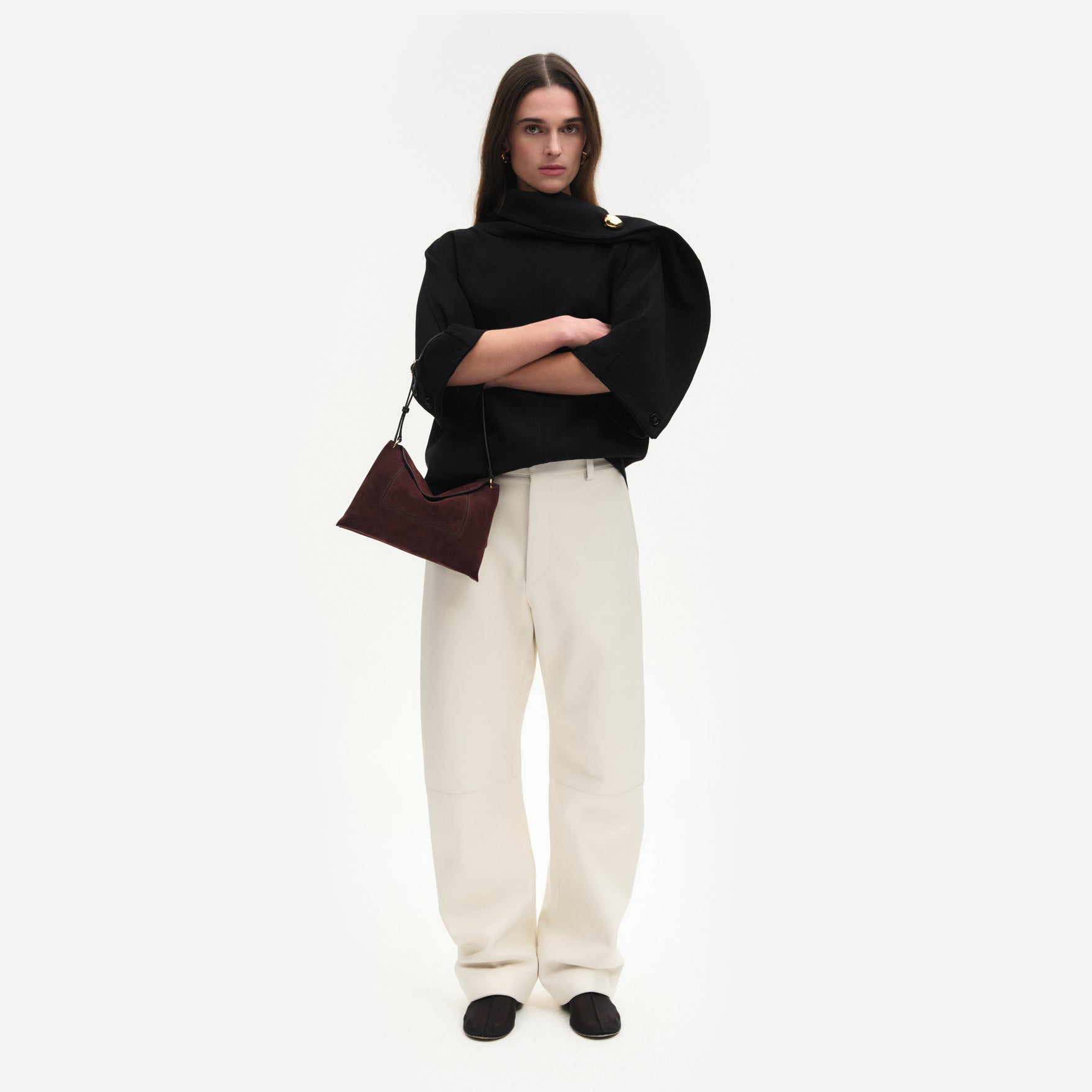 Wandler Penelope Slouch Bag in the color Acai Suede made from calf leather with golden hardware and adjustable slim strap, pictured being worn by model on the forearm.