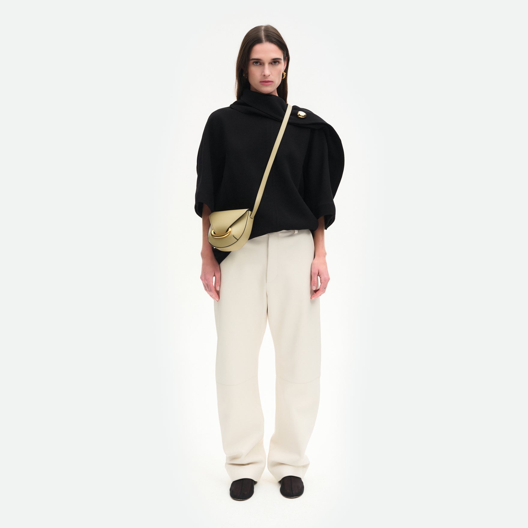Wandler Veneto Crossbody Small in Peper, dark beige, made from Italian calf leather with golden clasp hardware and structured silhouette, pictured on model, worn in crossbody style, full body picture. 