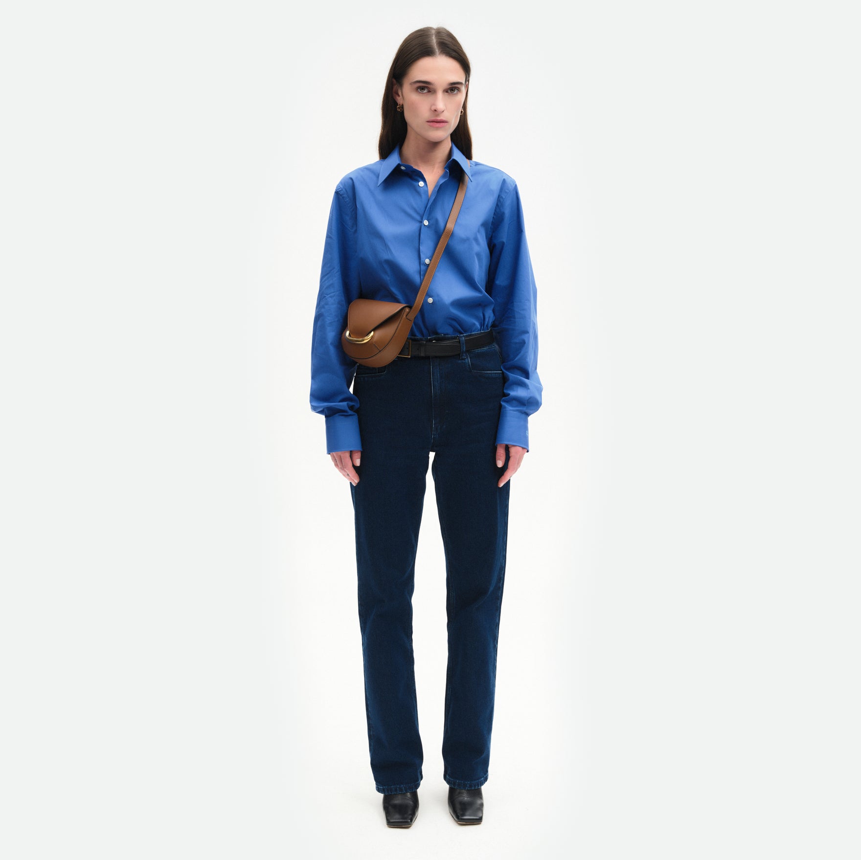 Wandler Veneto Crossbody Small in Saddle, warm brown, made from Italian calf leather with golden clasp hardware and structured silhouette, pictured being worn by model in crossbody style, full body picture. 
