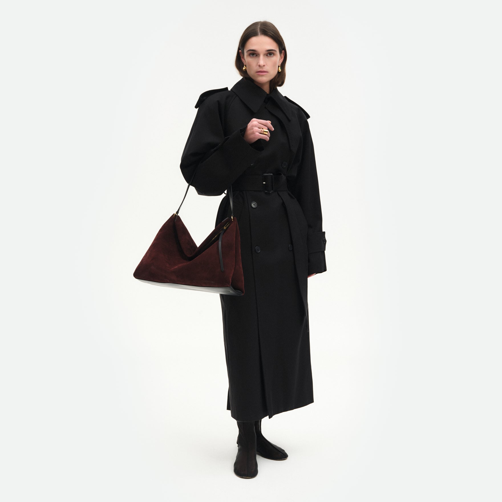 Wandler Penelope Tote in the color Acai Suede, made from Italian calf leather with golden hardware and soft structured silhouette, pictured being worn by model on the forearm.