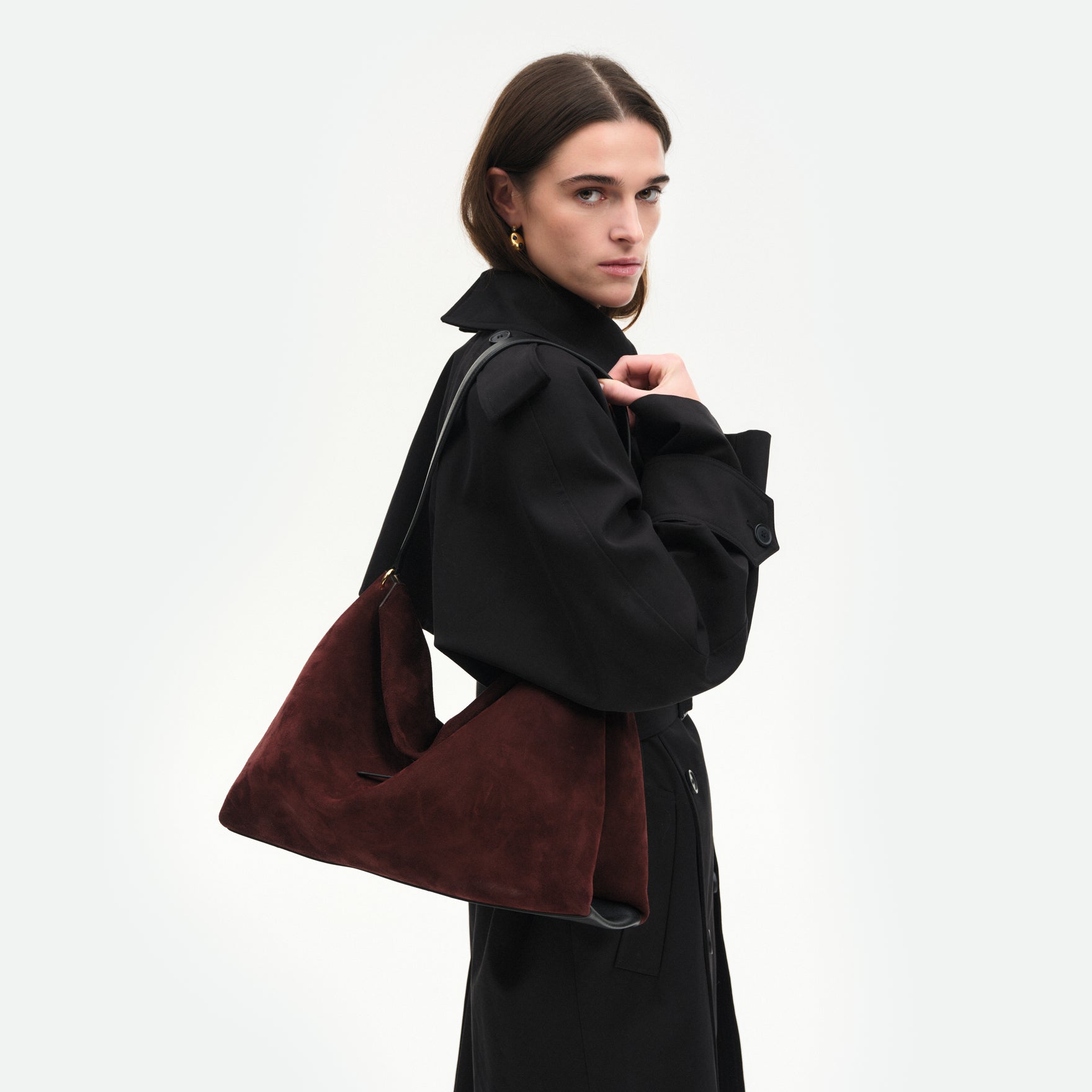 Wandler Penelope Tote in the color Acai Suede, made from Italian calf leather with golden hardware and soft structured silhouette, pictured on being worn by model on the shoulder.