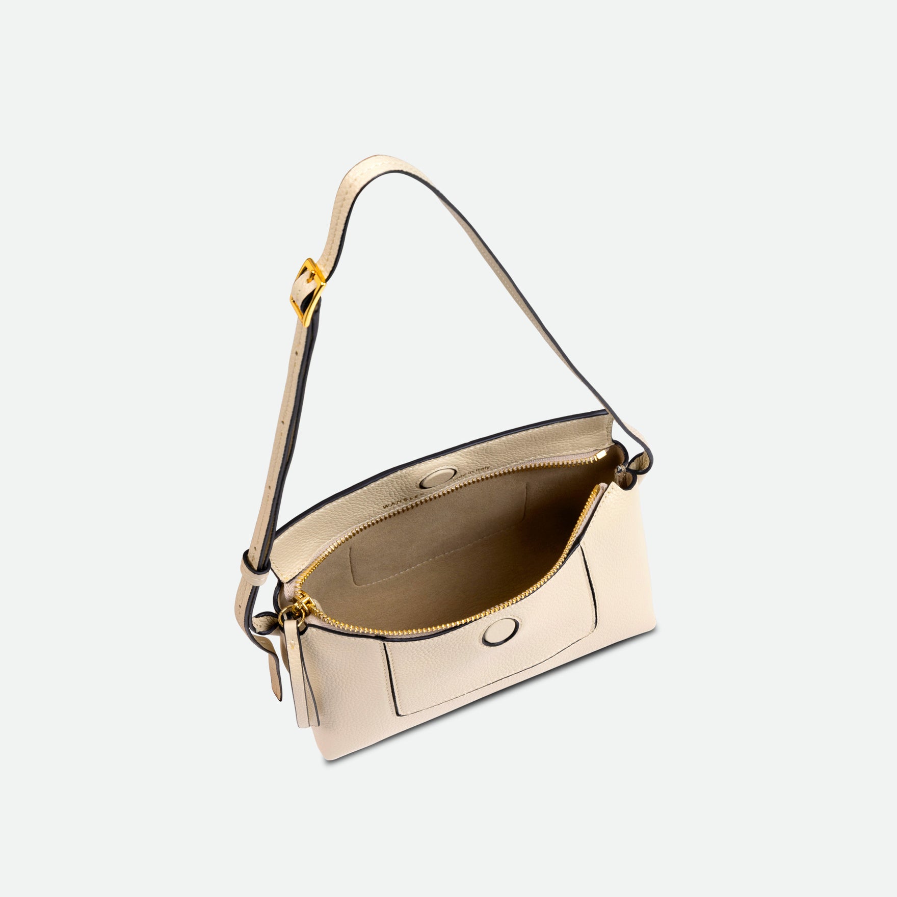 Wandler Penelope Slouch Mini in Beige Crust, Italian calf leather with golden hardware and slim adjustable strap, pictured from above with open zipper, allowing a glimpse into the inside of the bag.