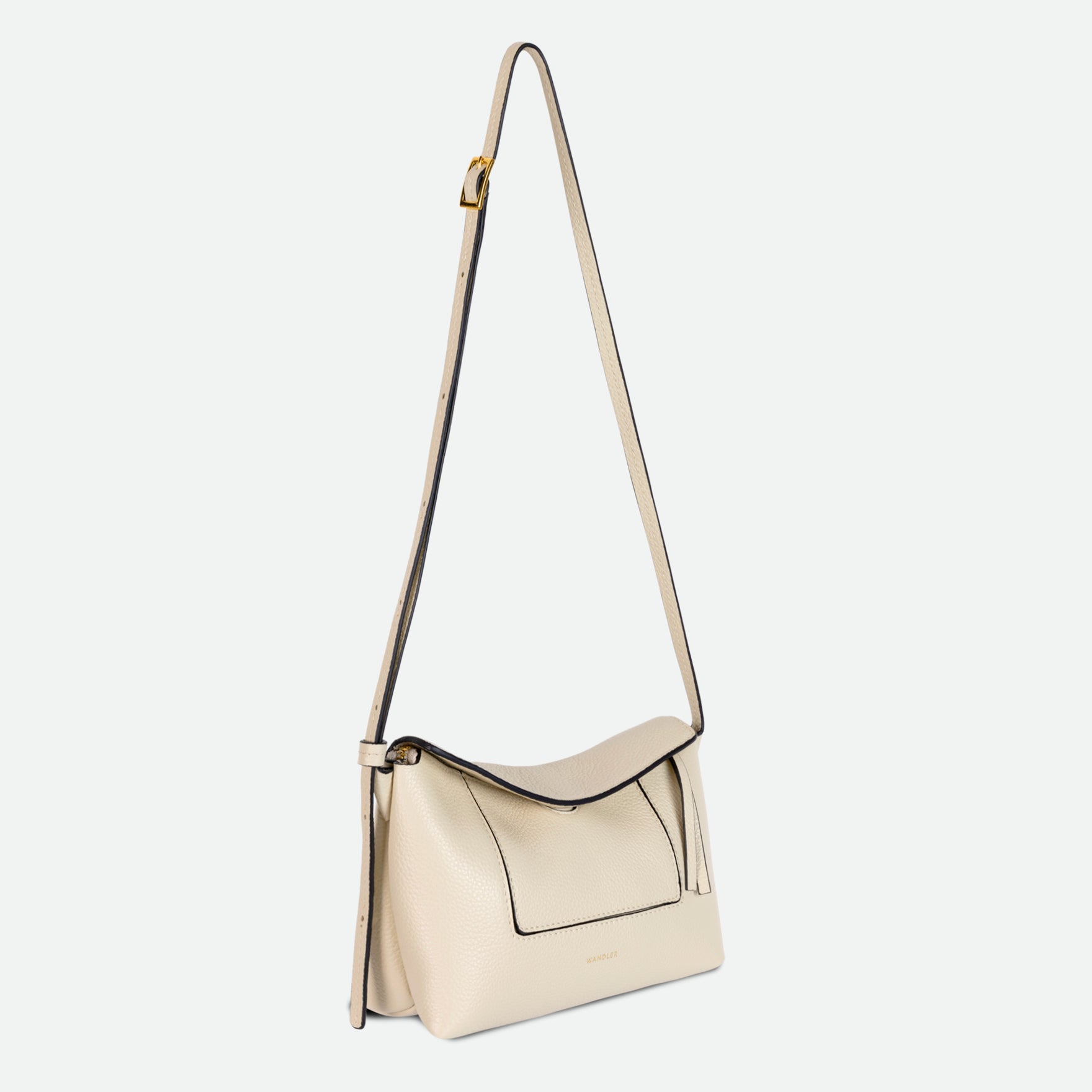 Wandler Penelope Slouch Mini in Beige Crust, Italian calf leather with golden hardware and slim adjustable strap, pictured with straps suspended into the air.