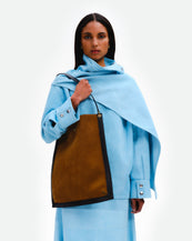 Wandler Penny Tote in the color Tabacco Suede, made from Italian calf leather with hand-painted black edges and golden hardware, pictured being worn on the shoulder by model.