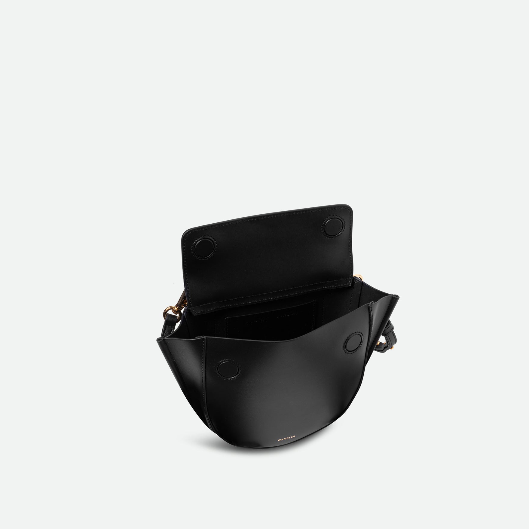 Wandler Hortensia Bag Mini in the color black, Italian calf leather with golden hardware, rounded silhouette and top handle. The bag is pictured from the front with the flap open, giving a slight view of the inside of the bag.