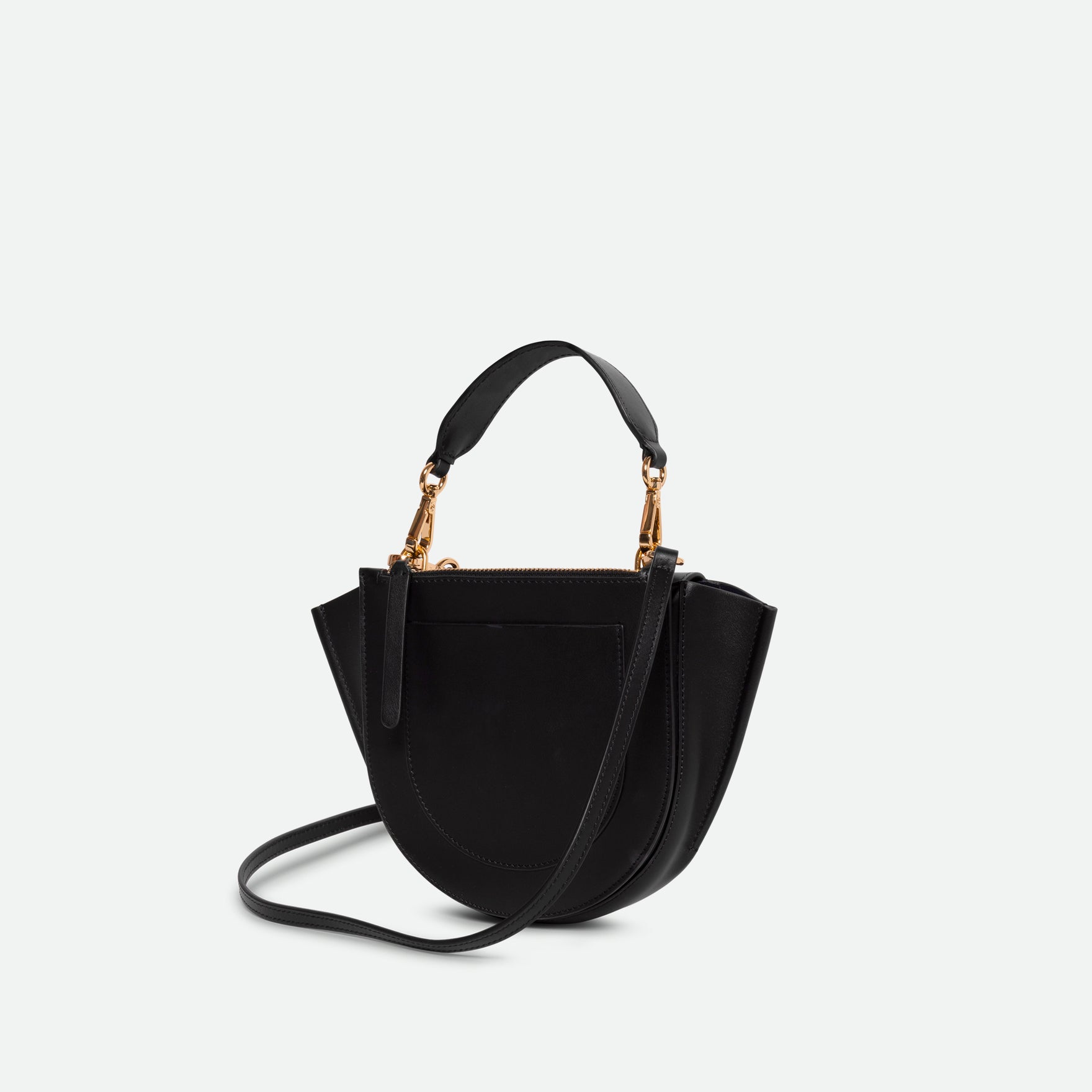 Wandler Hortensia Bag Mini in the color black, Italian calf leather with golden hardware, rounded silhouette and top handle, backside view. 