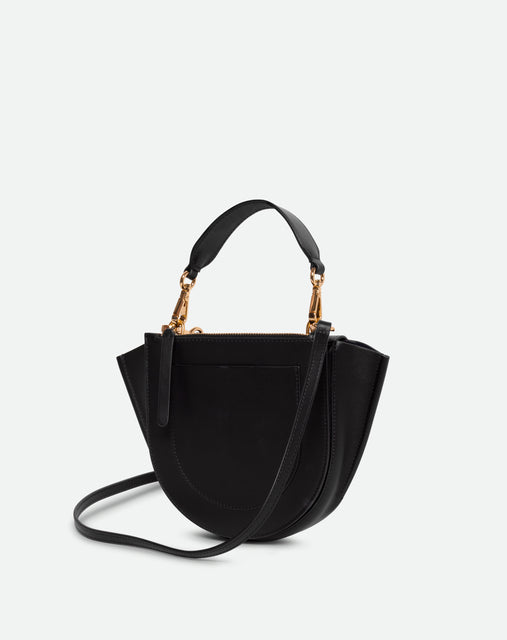 Wandler Hortensia Bag Mini in the color black, Italian calf leather with golden hardware, rounded silhouette and top handle, backside view. 