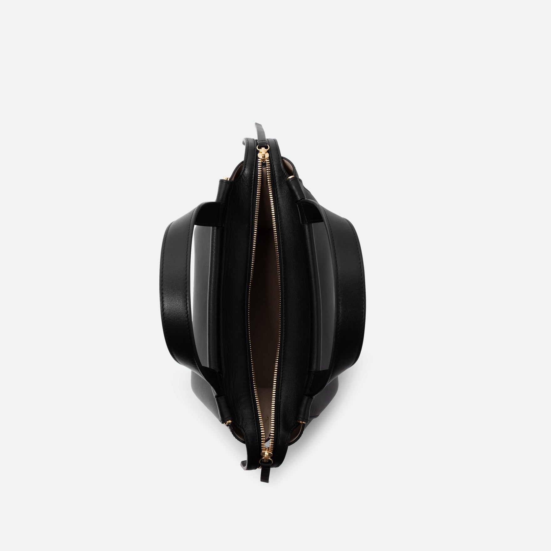Wandler Ida Bag in the color Black, made from Italian calf leather with golden hardware and sculptural top handle, pcitured from above with the bag open.