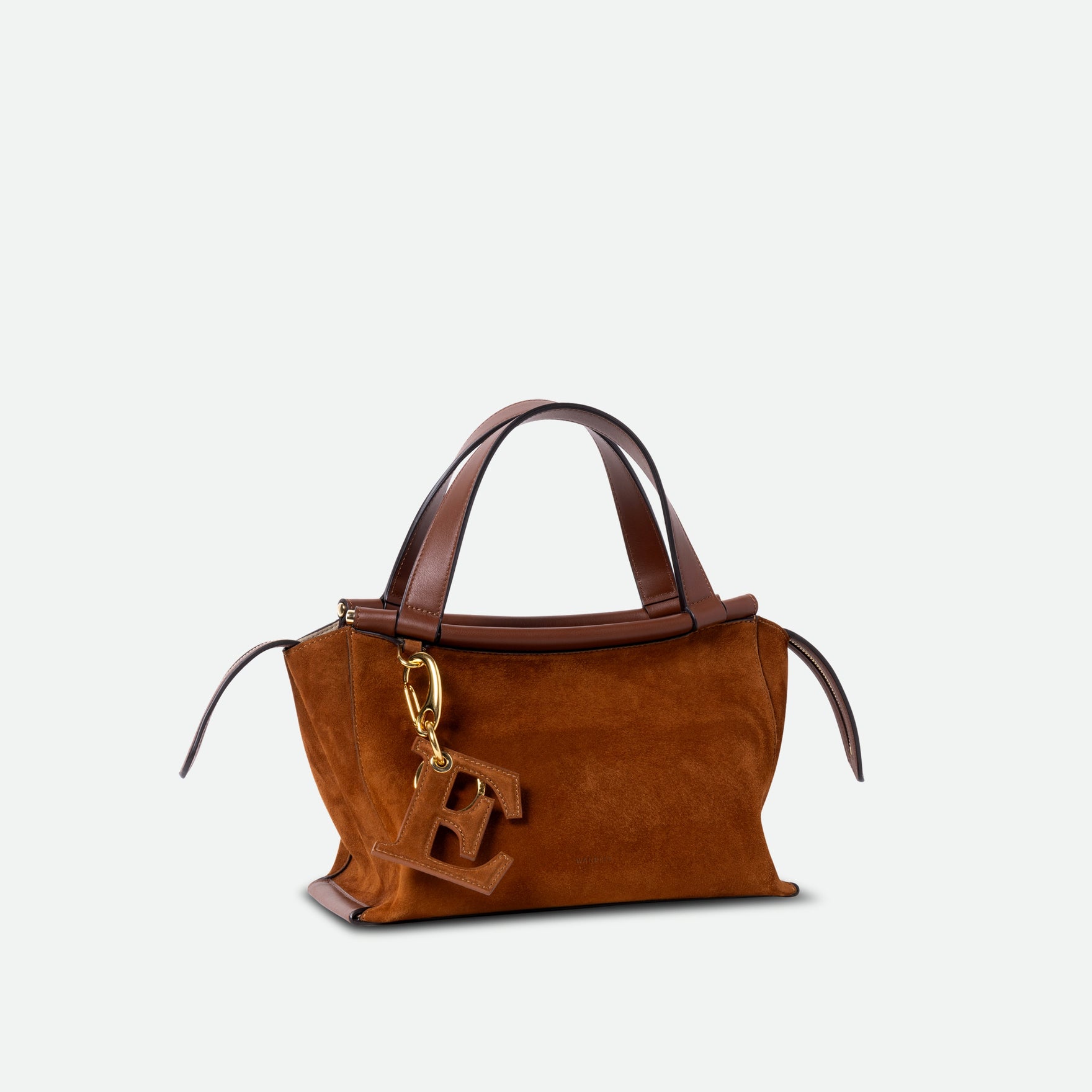 Wandler Ida Bag in the color Tan Suede, made from Italian calf leather with golden hardware and sculptural top handle, pictured with bag charm.