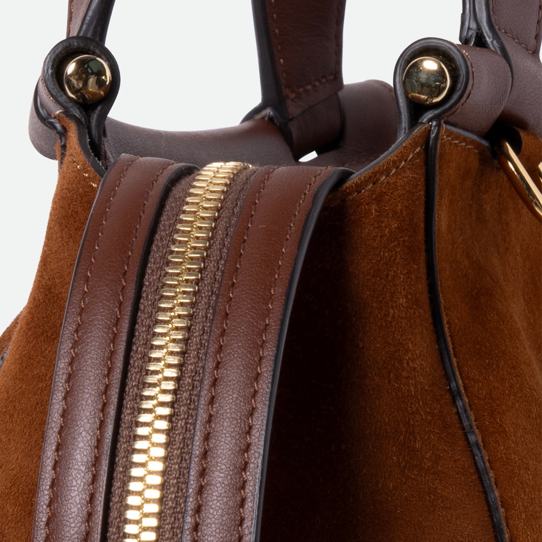 Wandler Ida Bag in the color Tan Suede, made from Italian calf leather with golden hardware and sculptural top handle, close up detailing the zipper.