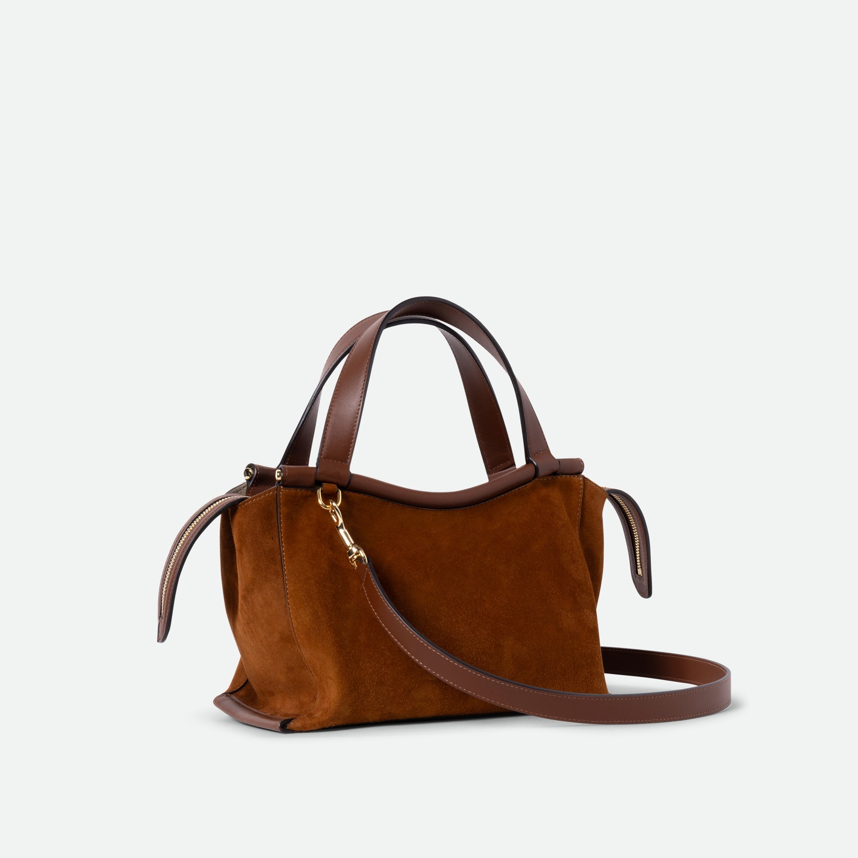 Wandler Ida Bag in the color Tan Suede, made from Italian calf leather with golden hardware and sculptural top handle, pictured with crossbody strap attached.