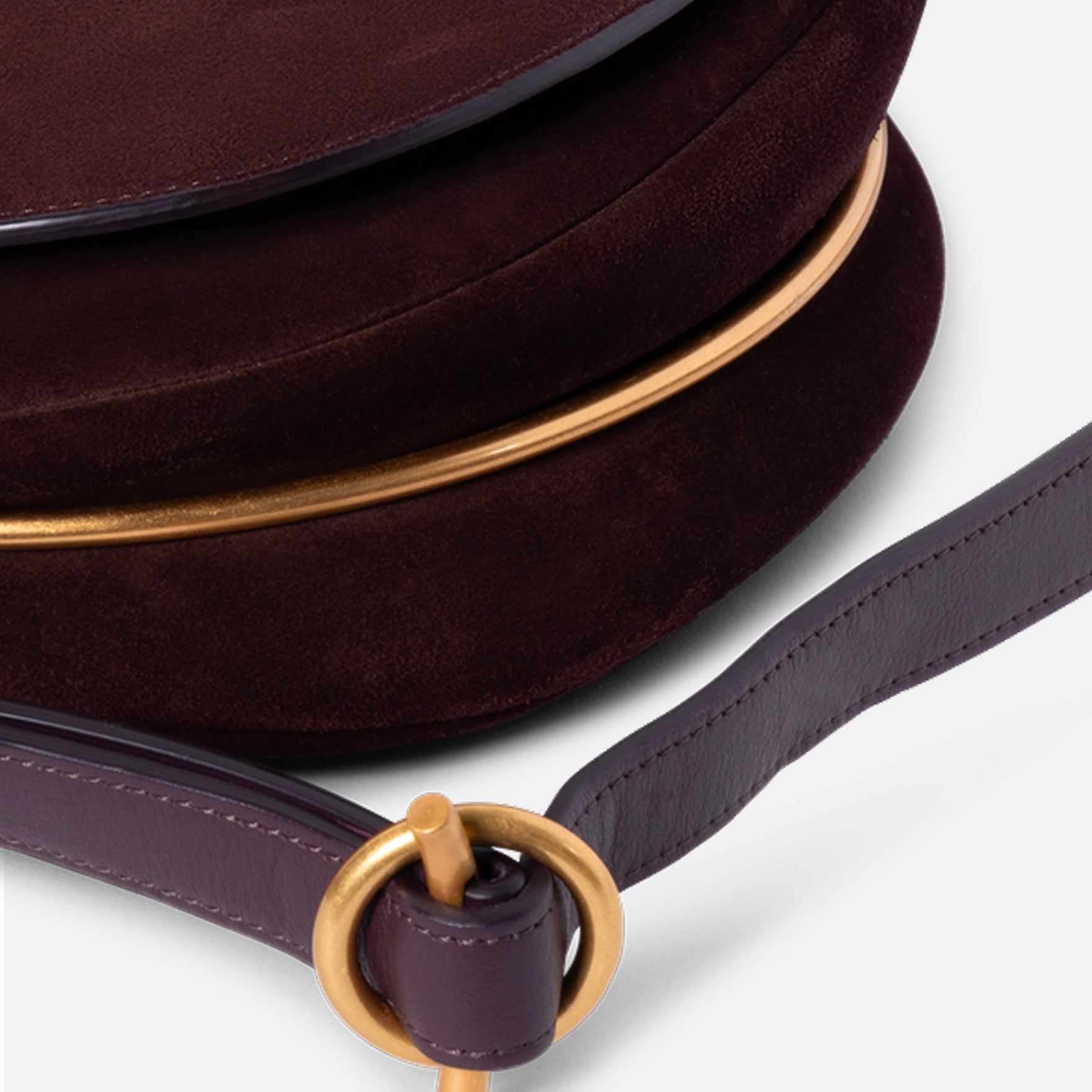 Wandler Kate Bag in the color Acai Suede, made from calf leather with golden hardware and adjustable shoulder strap, close up detailing the strap and leather.