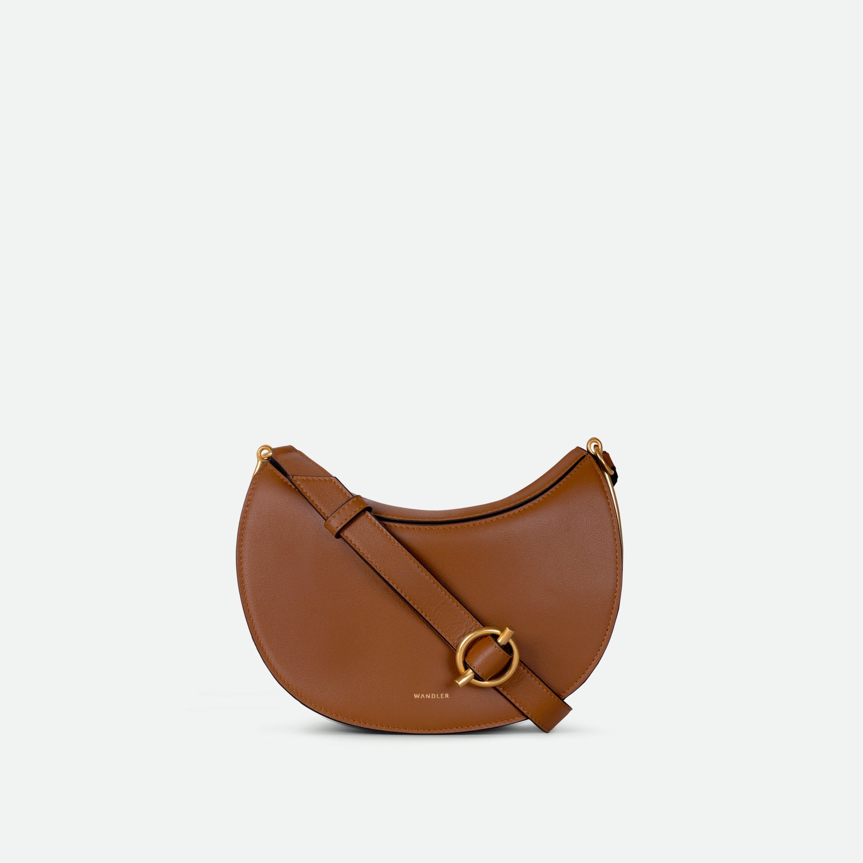 Wandler Kate Saddle Bag in Saddle, made from calf leather with golden hardware and adjustable shoulder strap, front view.