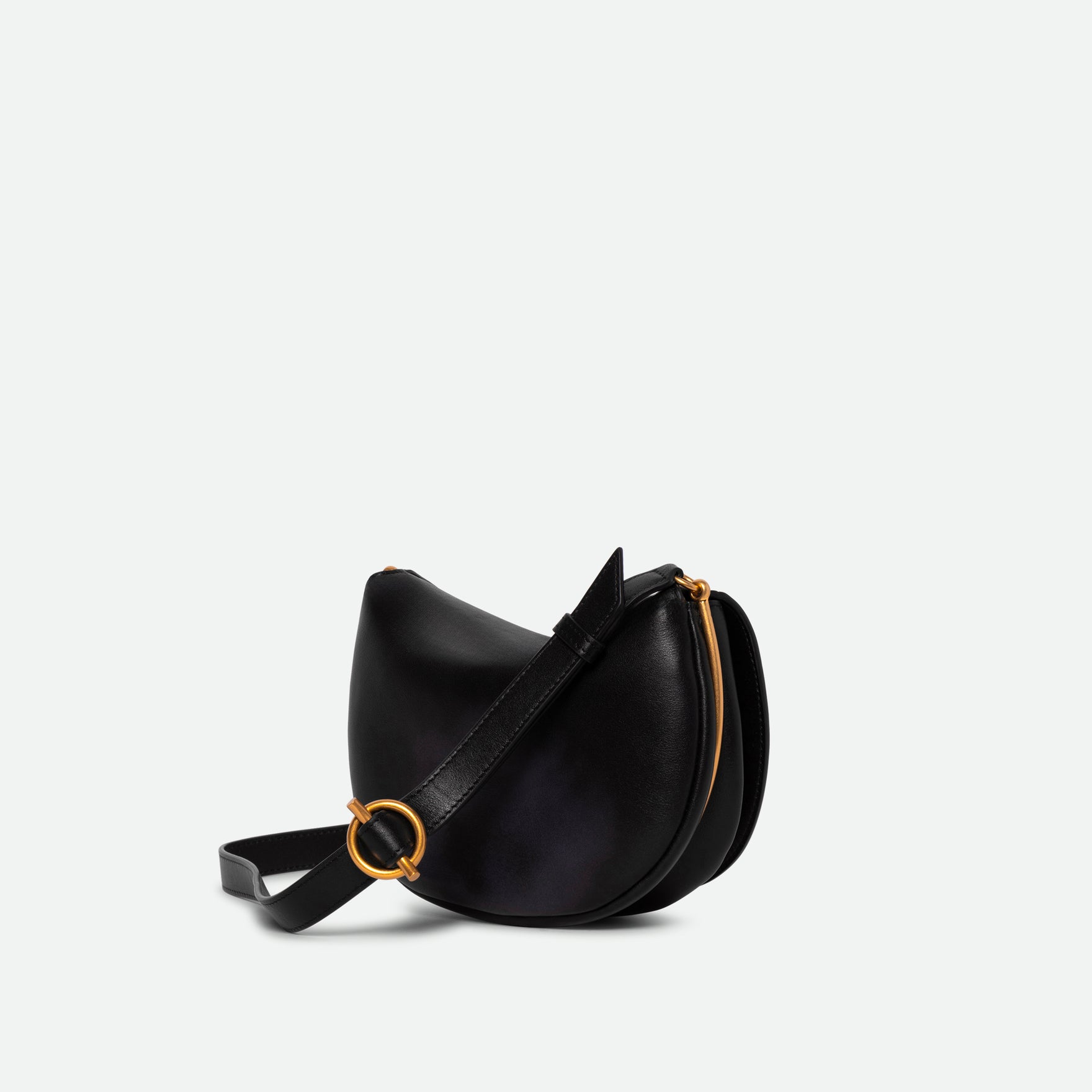 Wandler Kate Bag in the color Black, made from Italian calf leather with golden hardware and adjustable shoulder strap, backside view, three quarters angle. 