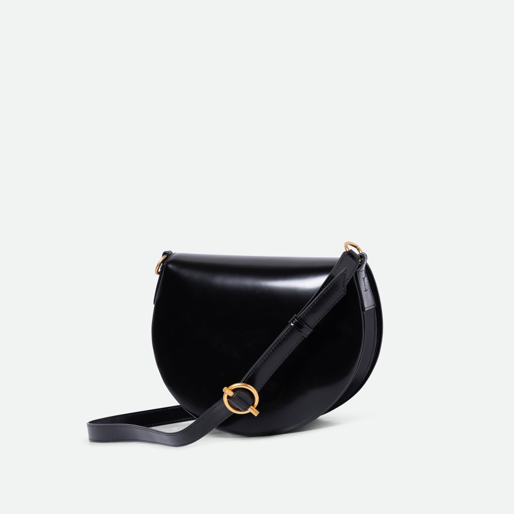 Wandler Kate Saddle Bag in the color Jazz Olive, deep dark green, calf leather with golden hardware and adjustable shoulder strap, thee quarters view.