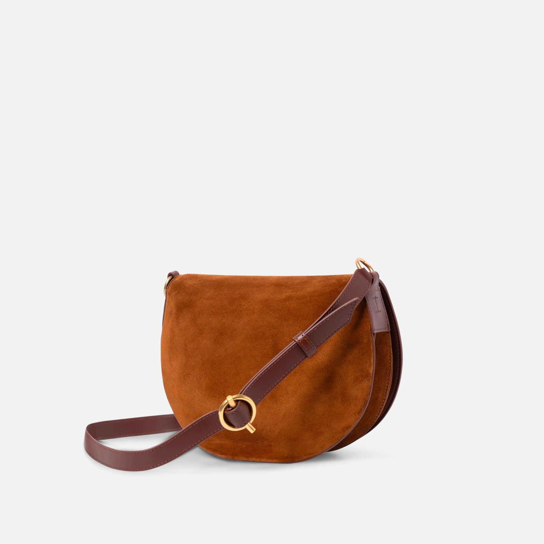 Wandler Kate Saddle Bag in the color Tan Suede, warm brown, calf leather with golden hardware and adjustable shoulder strap, three quarters view.