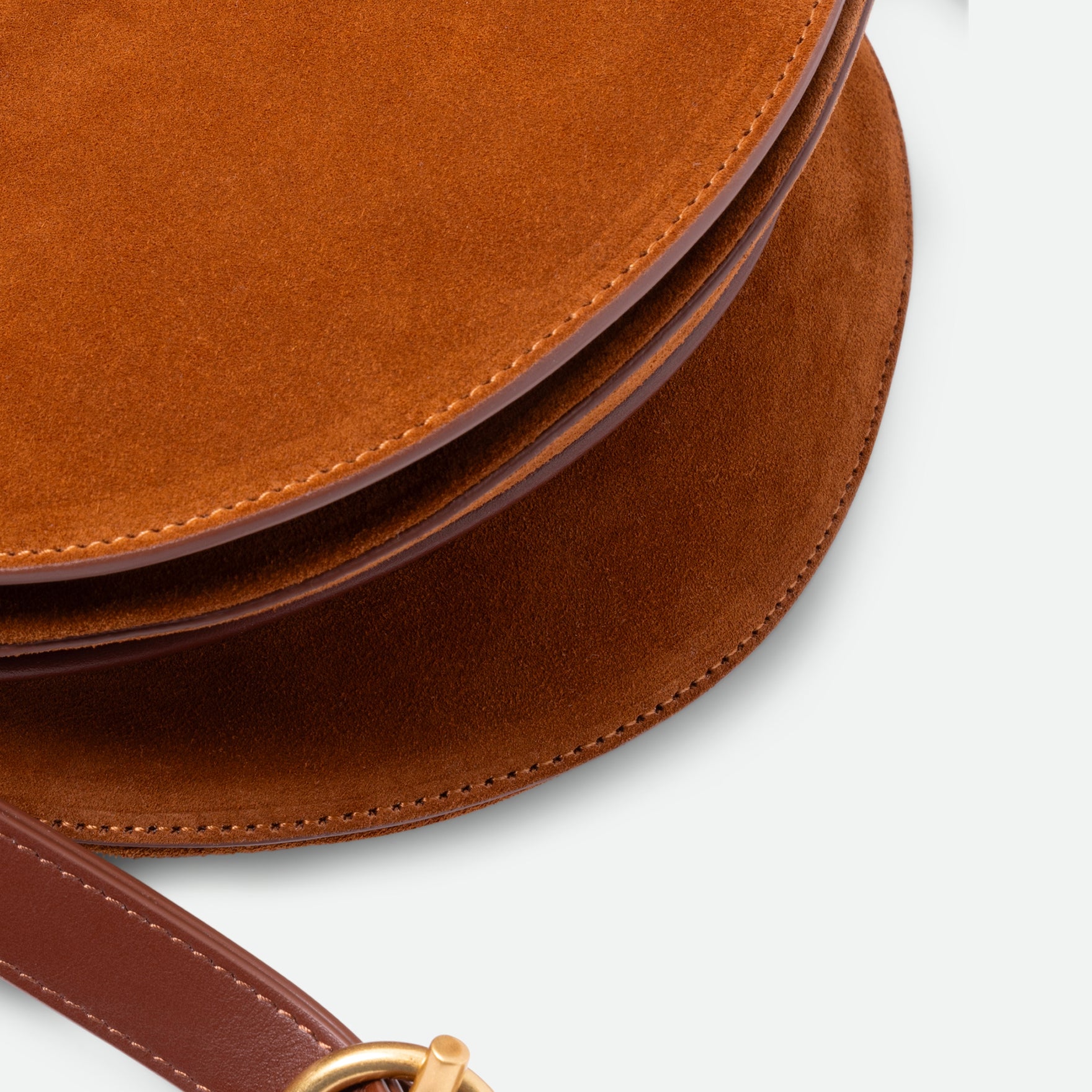 Wandler Kate Saddle Bag in the color Tan Suede, warm brown, calf leather with golden hardware and adjustable shoulder strap, close up detailing the leather. 