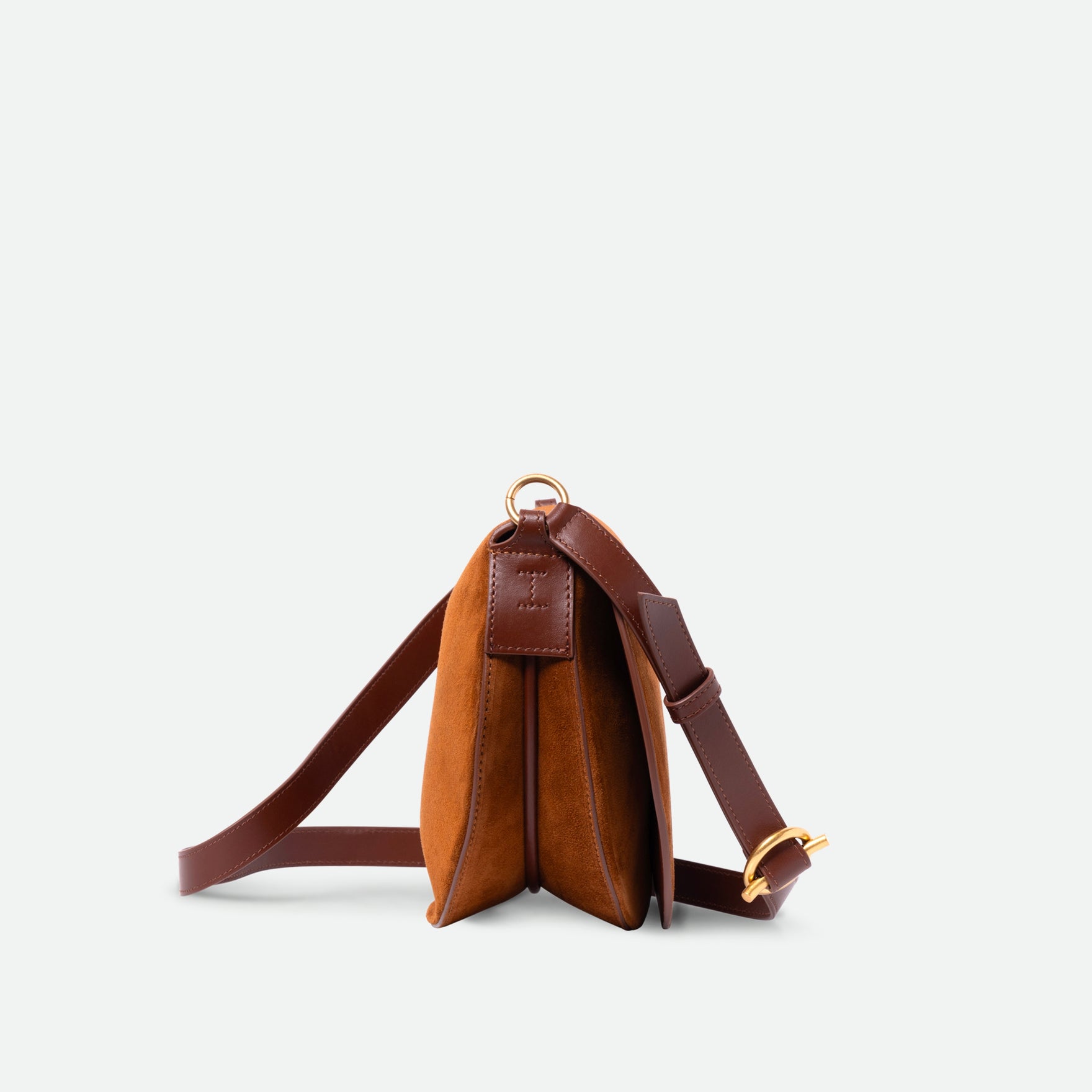 Wandler Kate Saddle Bag in the color Tan Suede, warm brown, calf leather with golden hardware and adjustable shoulder strap, side view.
