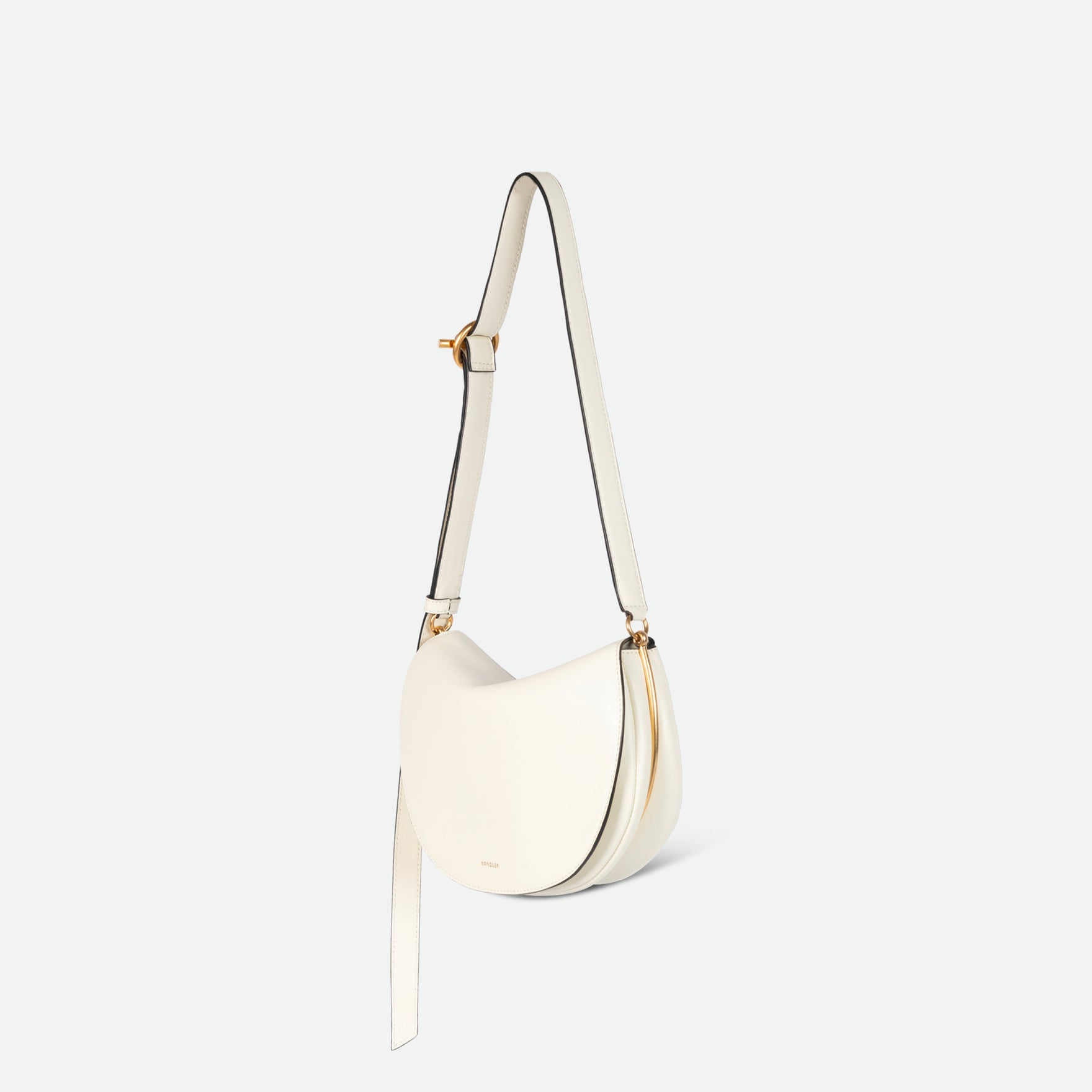 Wandler Kate Bag in the color Luck, white, Italian calf leather with golden hardware and adjustable shoulder strap, backside view, with the straps suspended into the air. 
