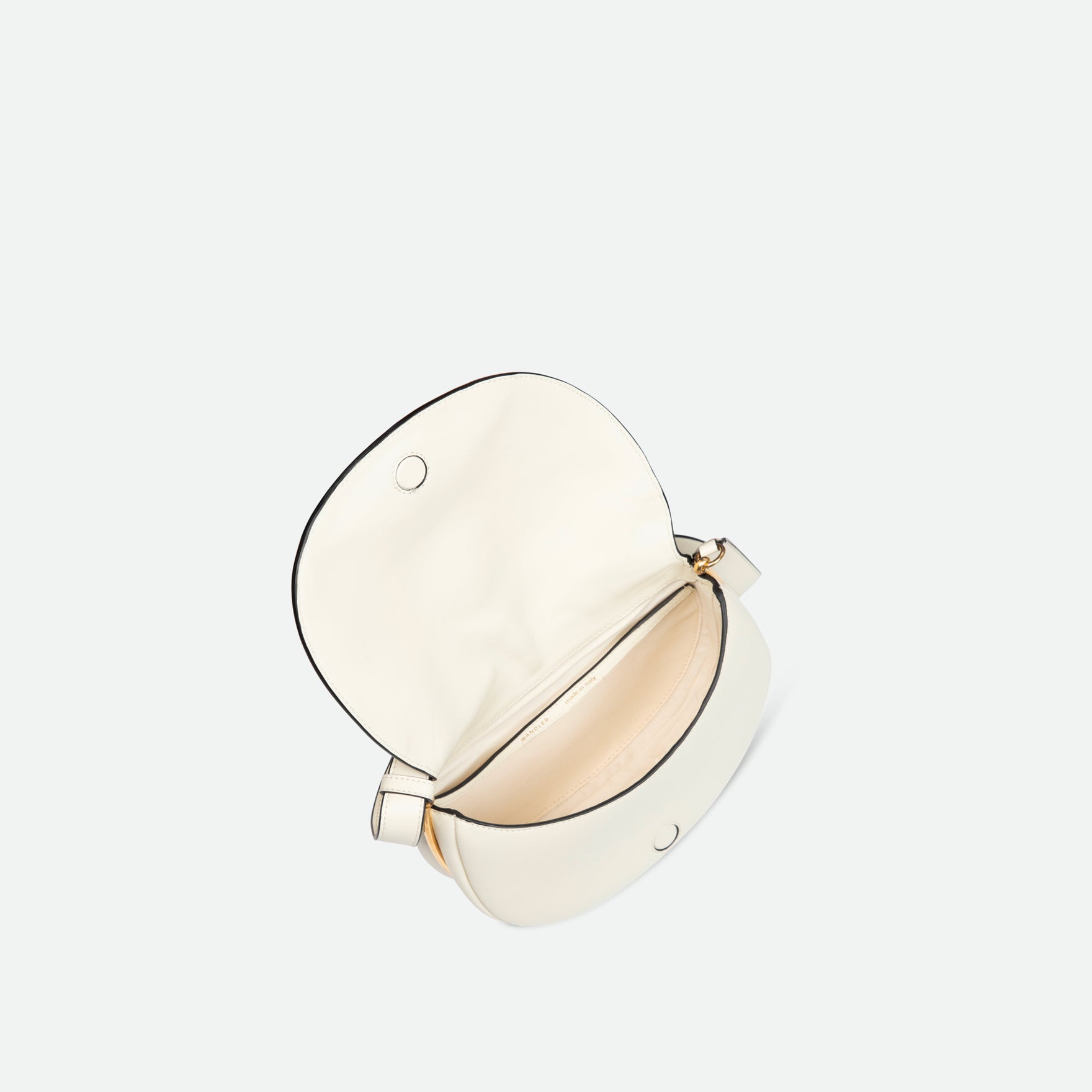 Wandler Kate Bag in the color Luck, white, Italian calf leather with golden hardware and adjustable shoulder strap, pictured from above, giving a glimpse into the inside of the bag. 